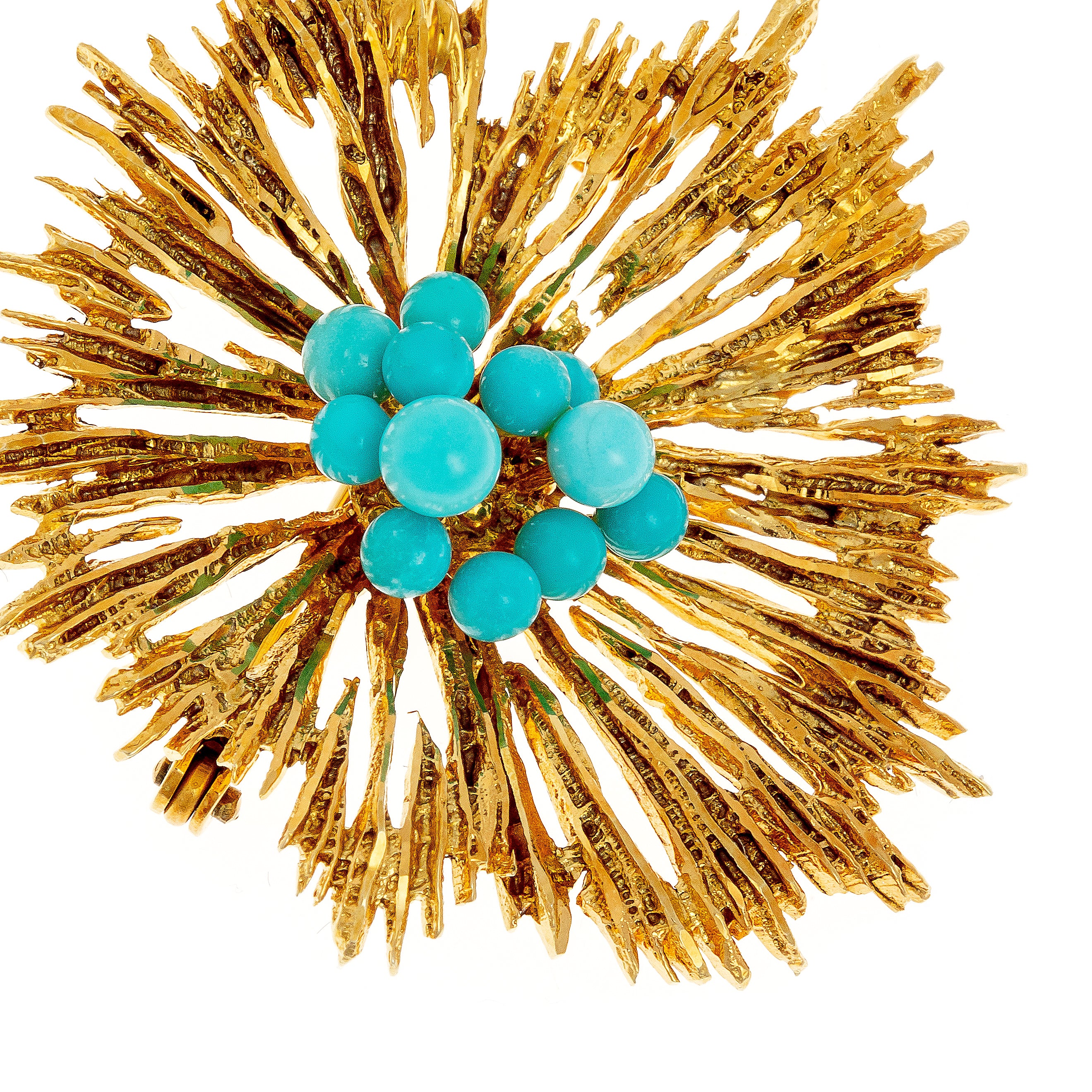 Close-up of a 1970s Brutalist gold brooch, highlighting the textured gold spikes and vibrant turquoise-colored bead cluster.