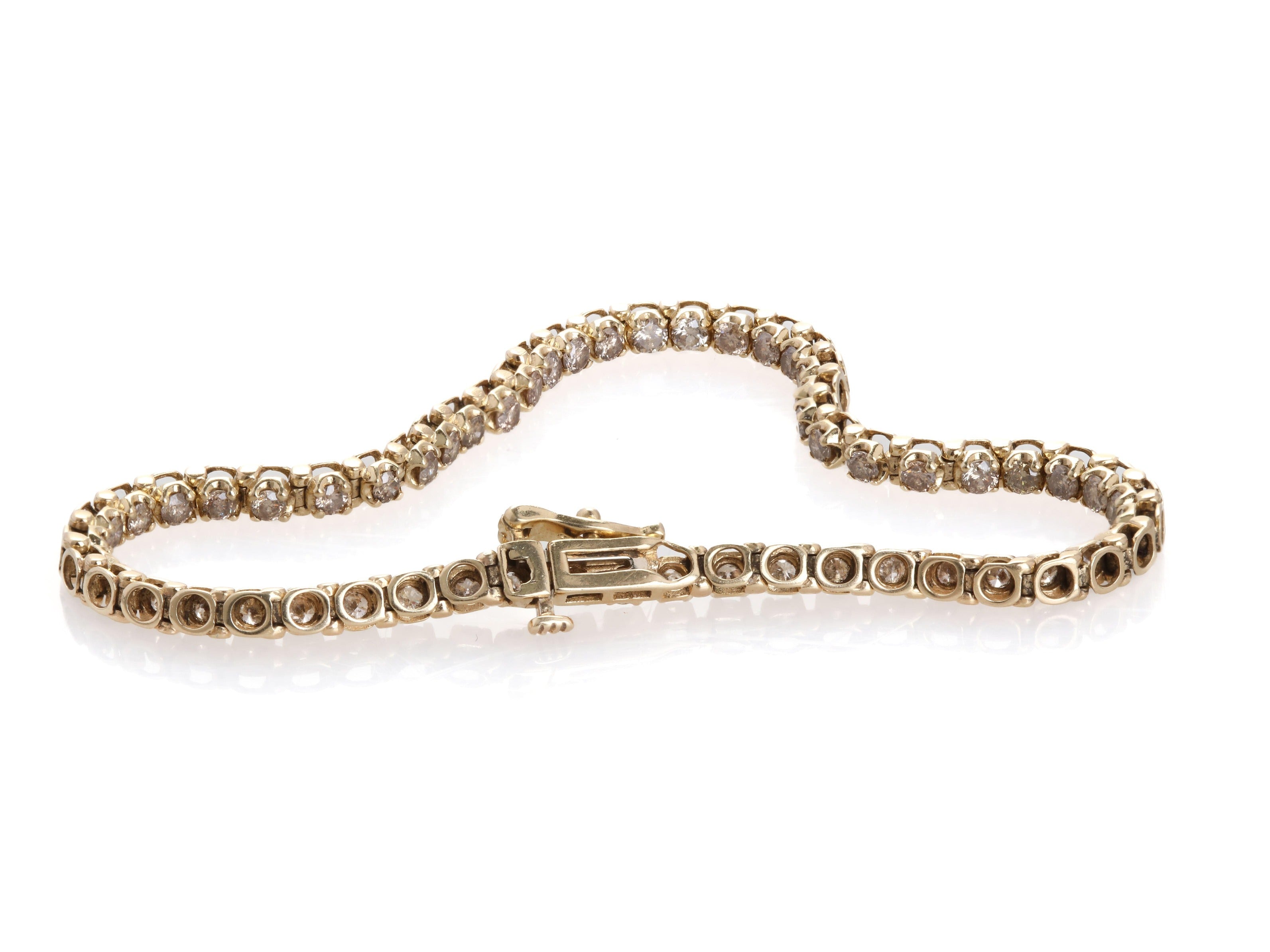Side profile of the gold bracelet, highlighting the prong-set diamonds and flexible design.