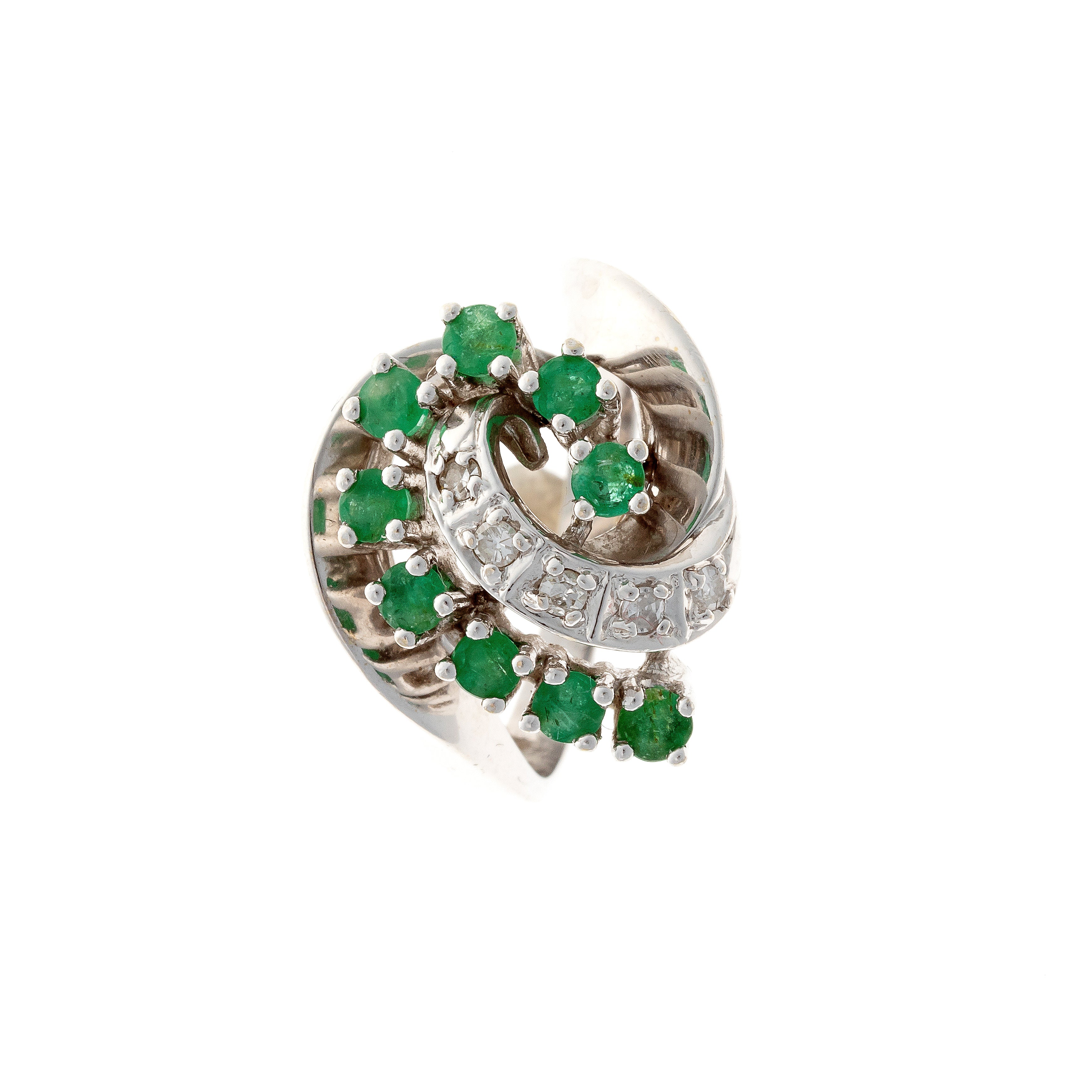 Top view of mid-century emerald and diamond swirl cocktail ring in white gold.