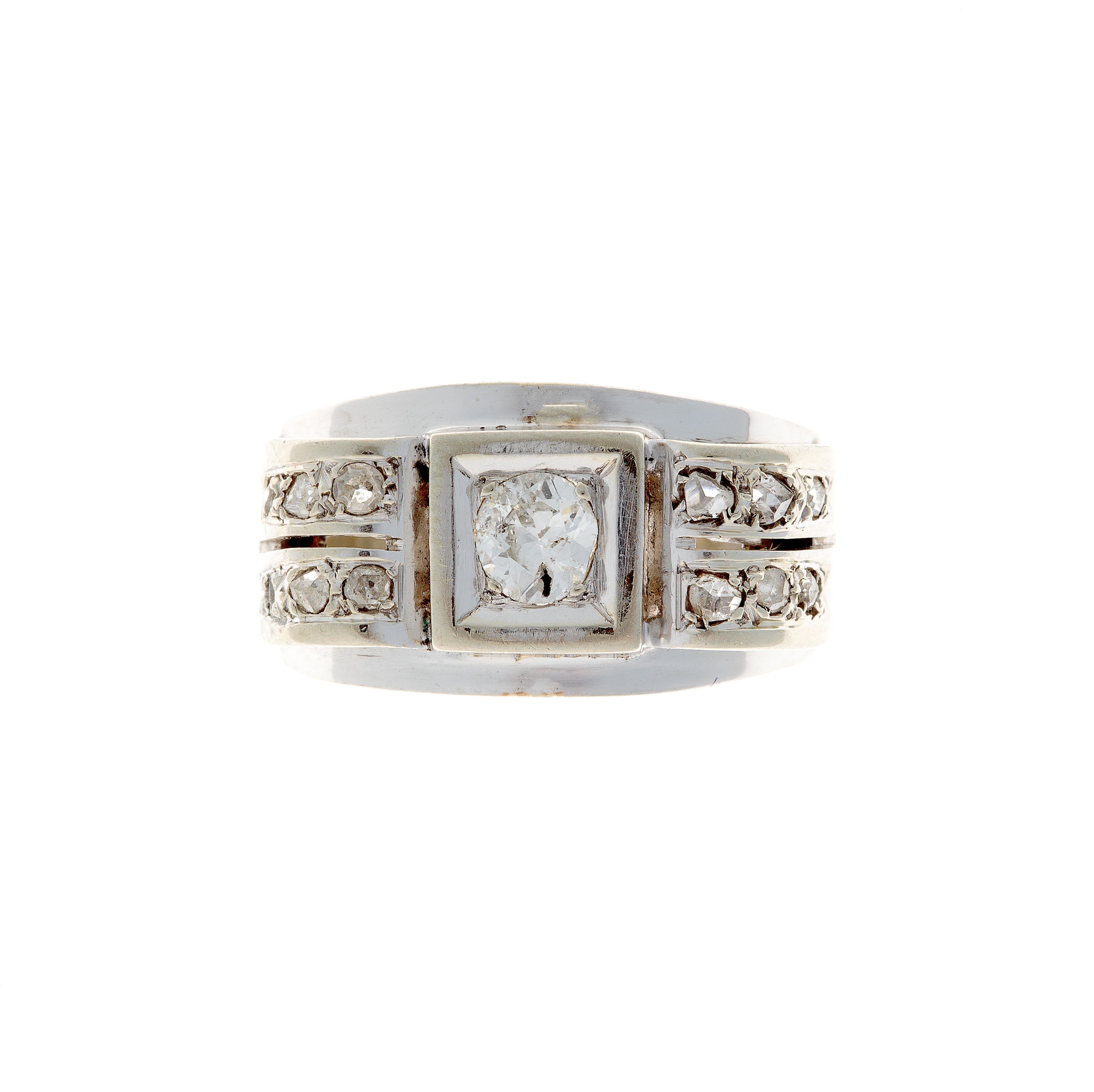 Top view of an Art Deco white gold diamond ring, showcasing its structured geometric setting and antique diamond cuts.