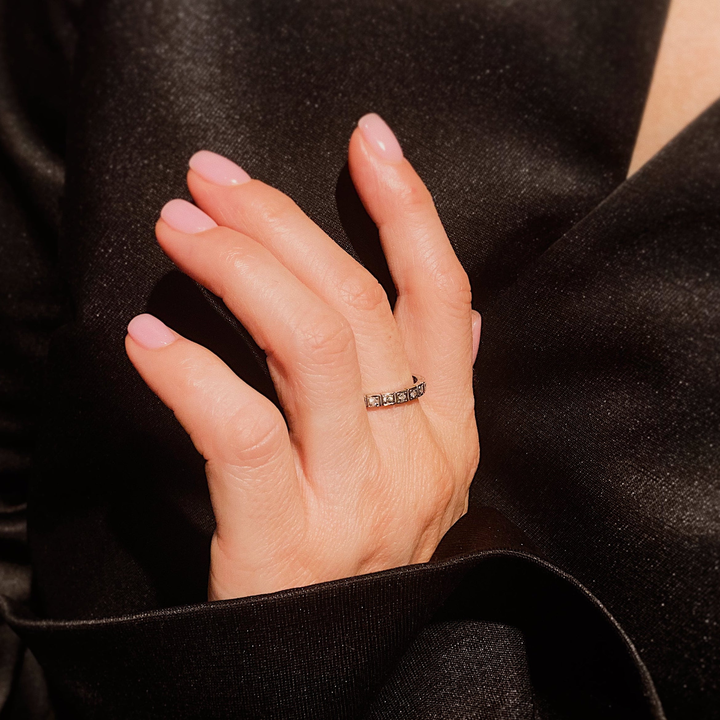 Woman wearing the Art Deco white gold geometric diamond eternity ring.