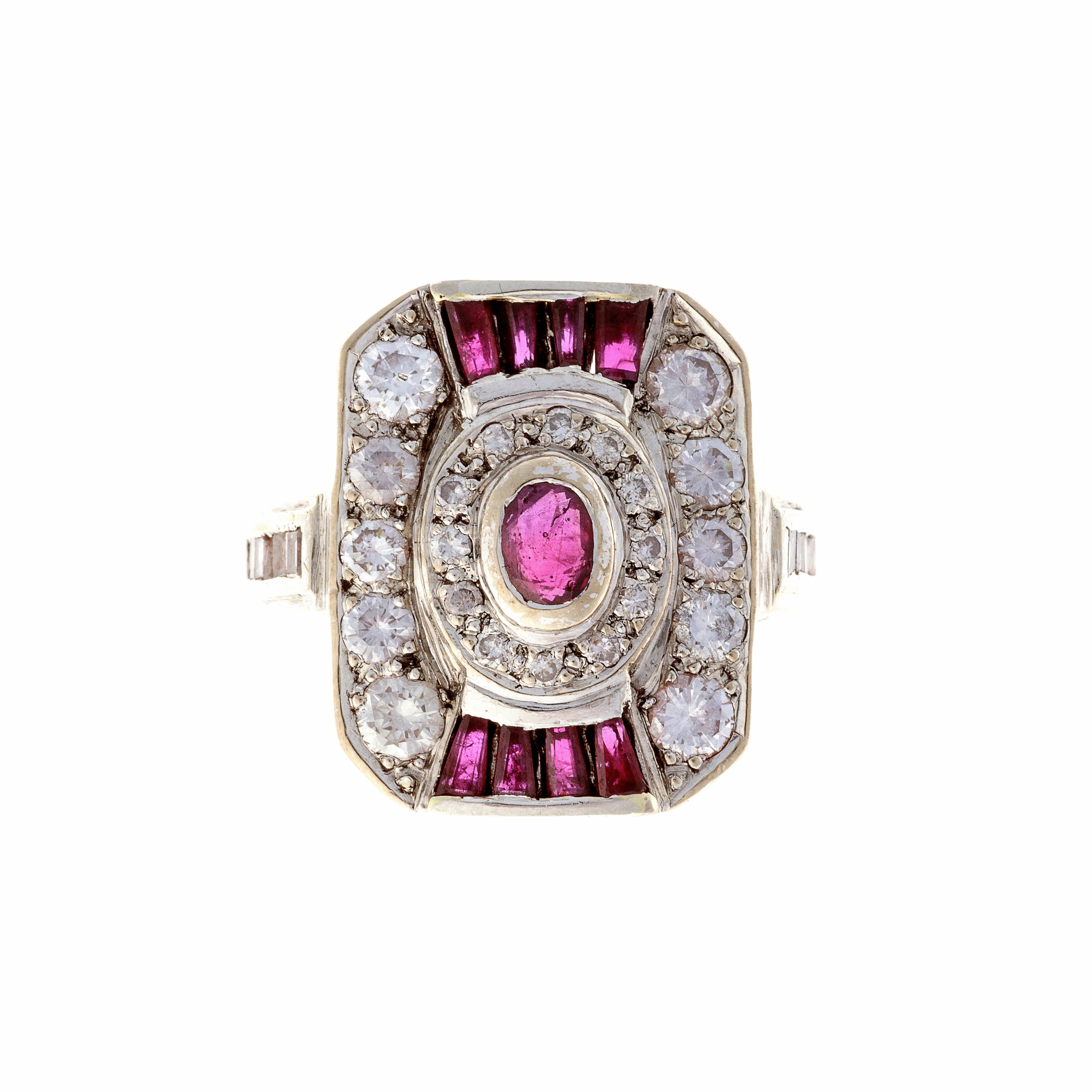 Art Deco 18K white gold cocktail ring with rubies and brilliant-cut diamonds in a stepped geometric design.