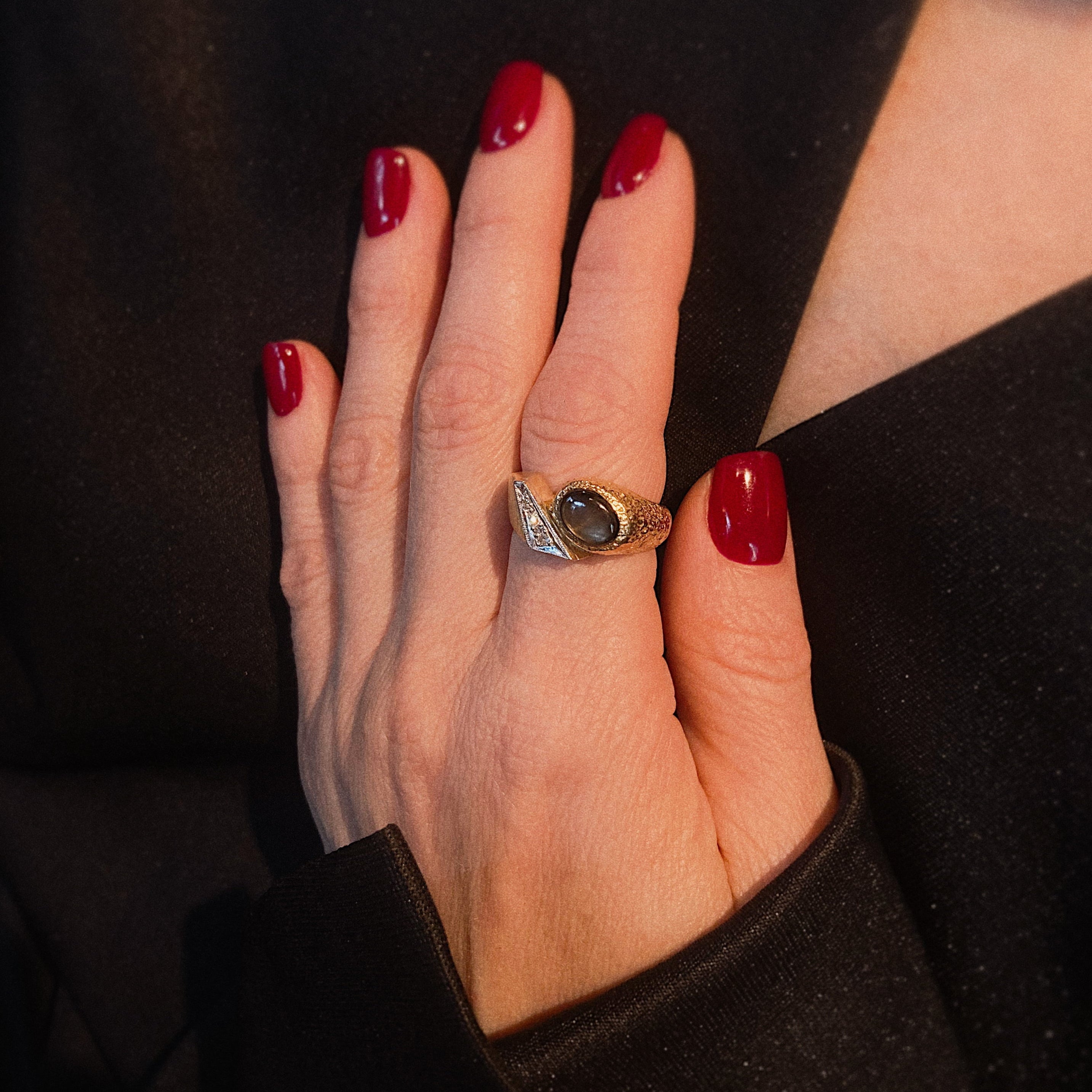 Model wearing the 1970s avant-garde gold ring with diamonds and star sapphire.