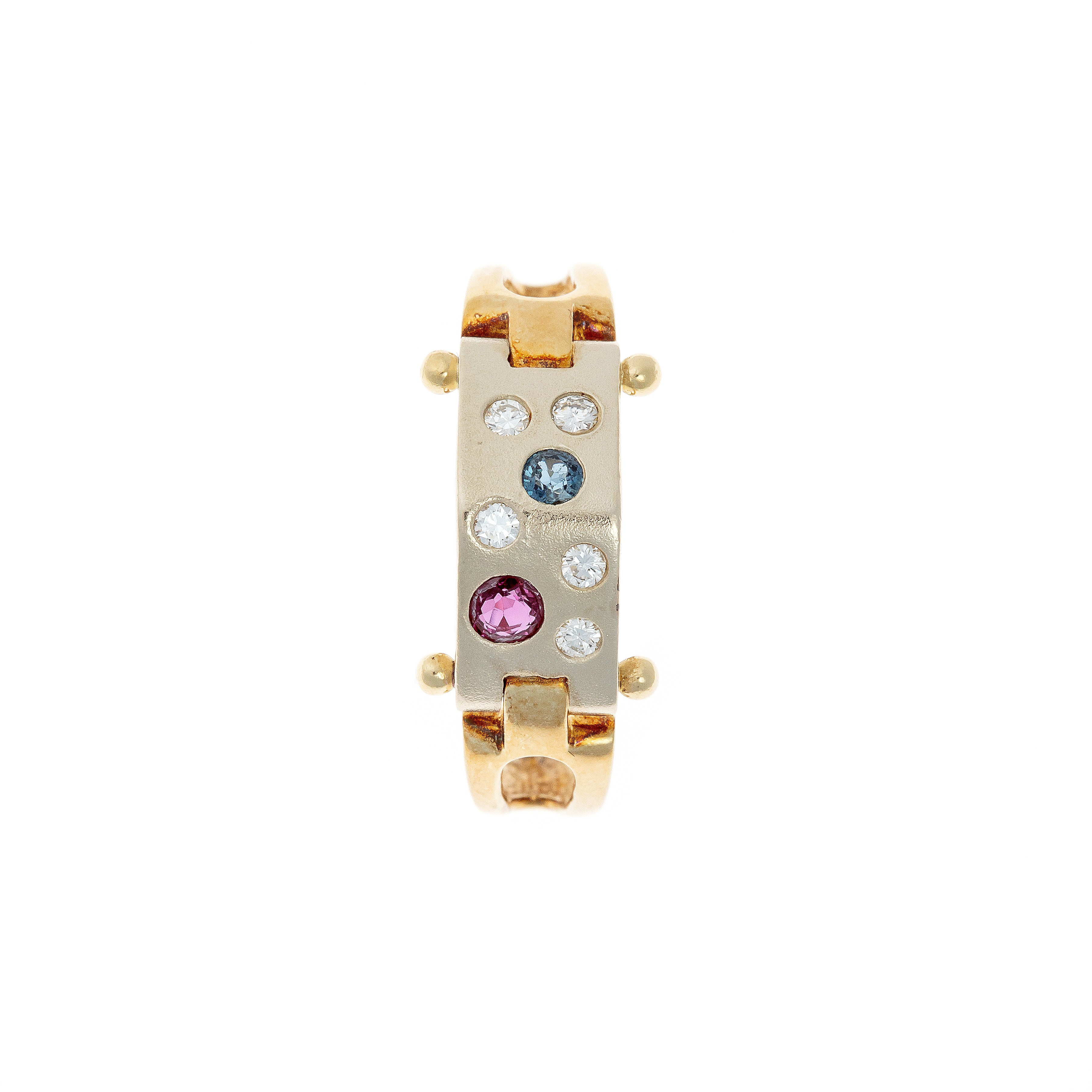 Top view of an Avant-Garde gold ring showcasing a brushed white gold panel with asymmetrically set diamonds, sapphire, and ruby.