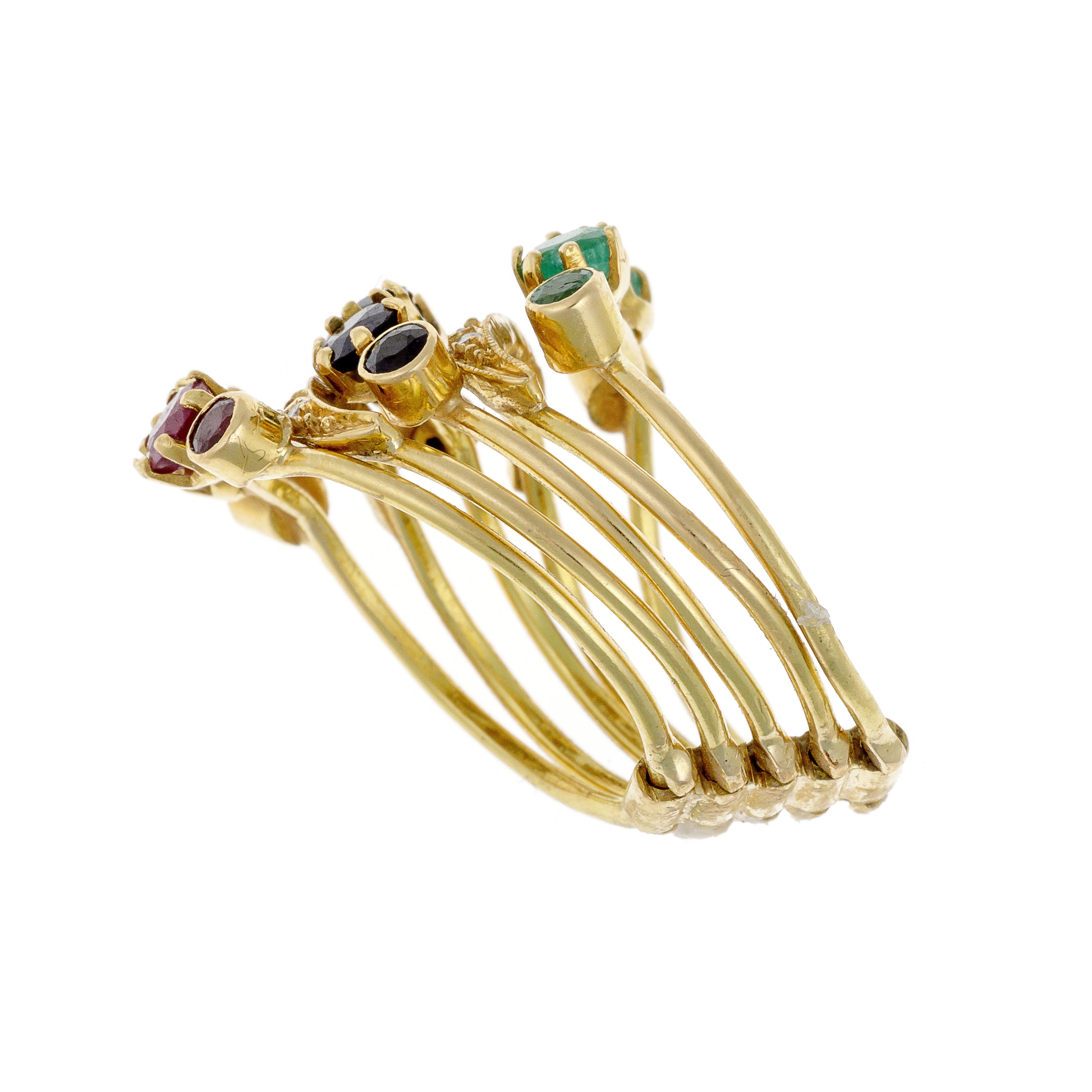 Close-up angled shot of bold gold ring with vibrant multistone detailing.