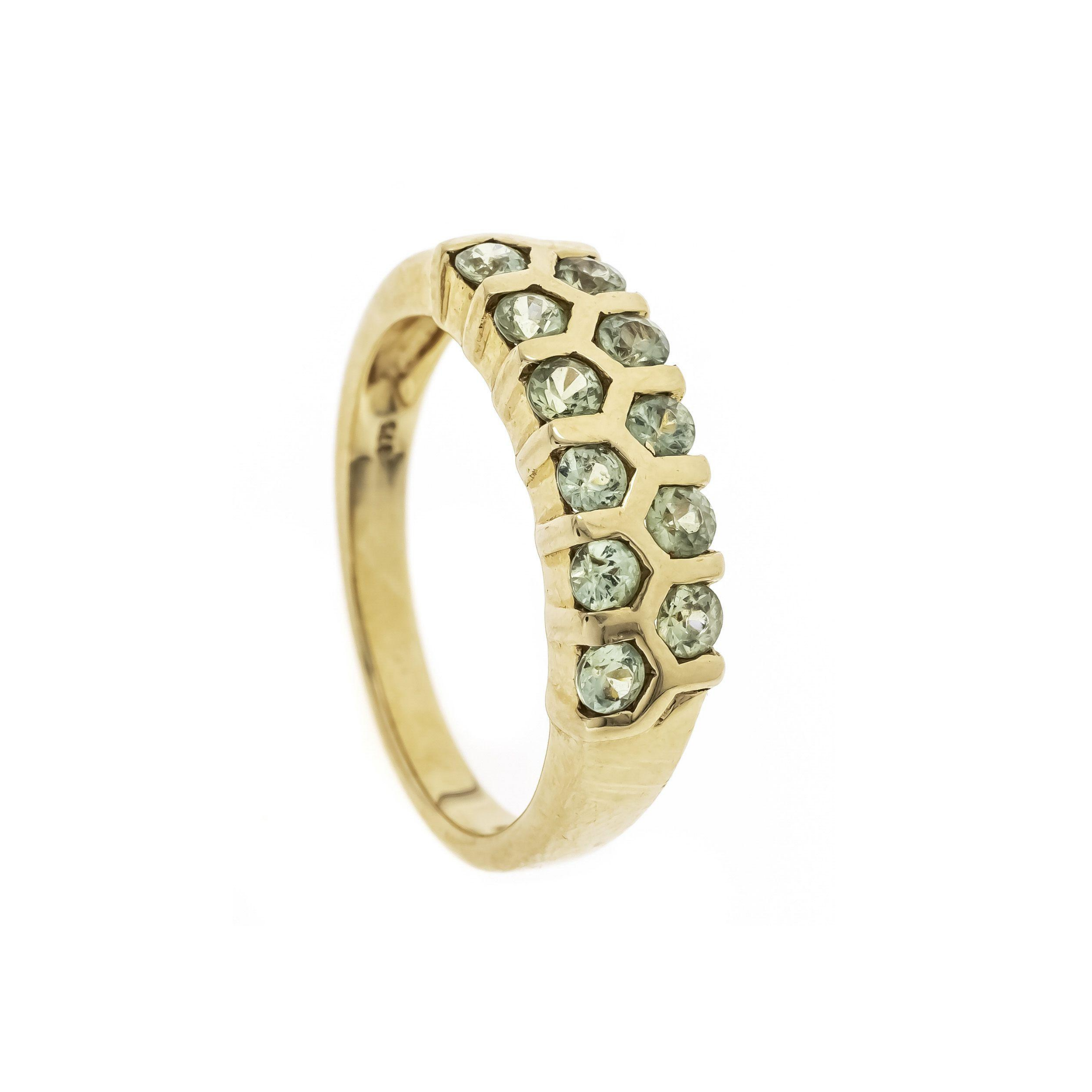 Top-down view of a Brutalist honeycomb peridot ring in 9K gold, highlighting structured hexagonal settings.