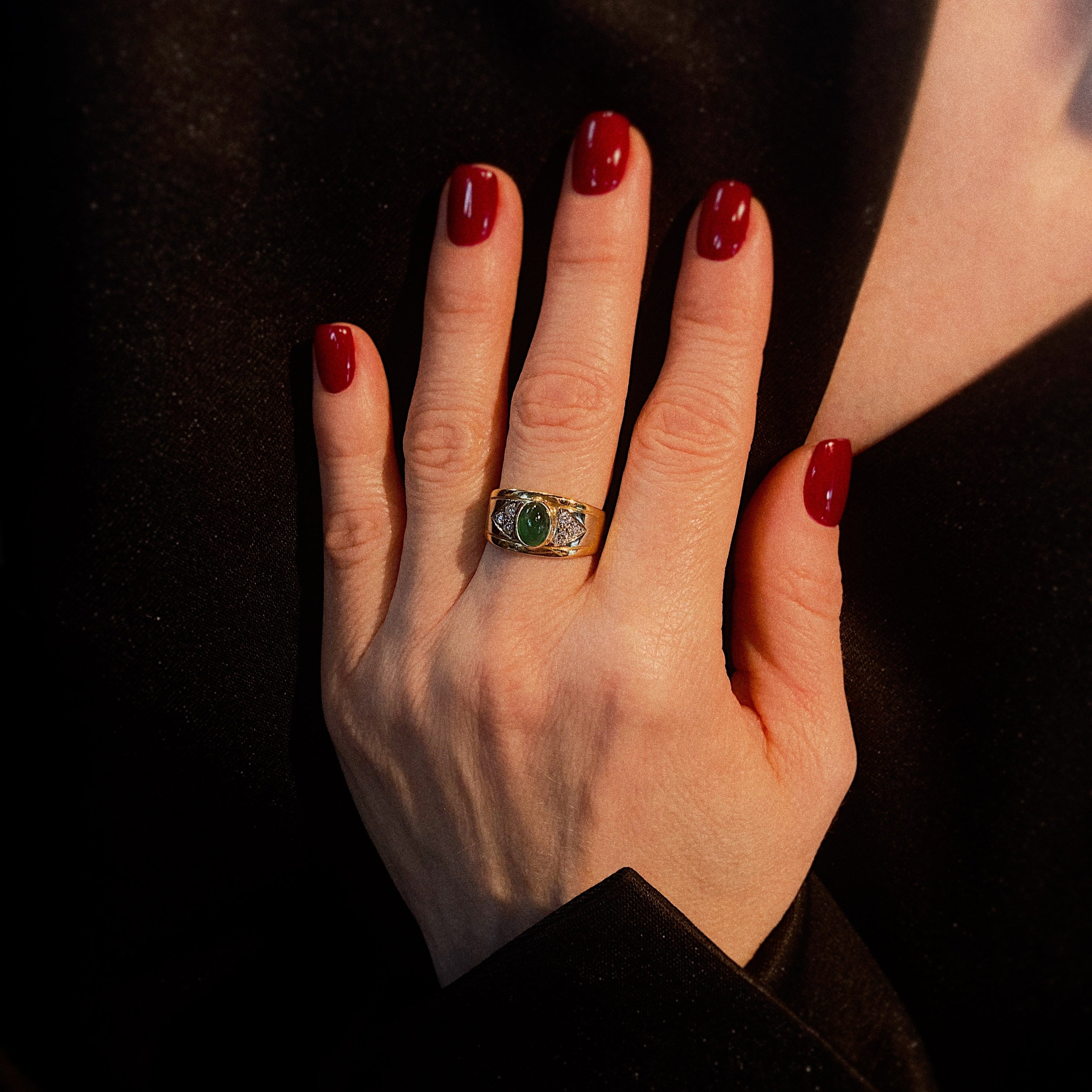 Model wearing the vintage gold cocktail ring with emerald cabochon and diamonds.