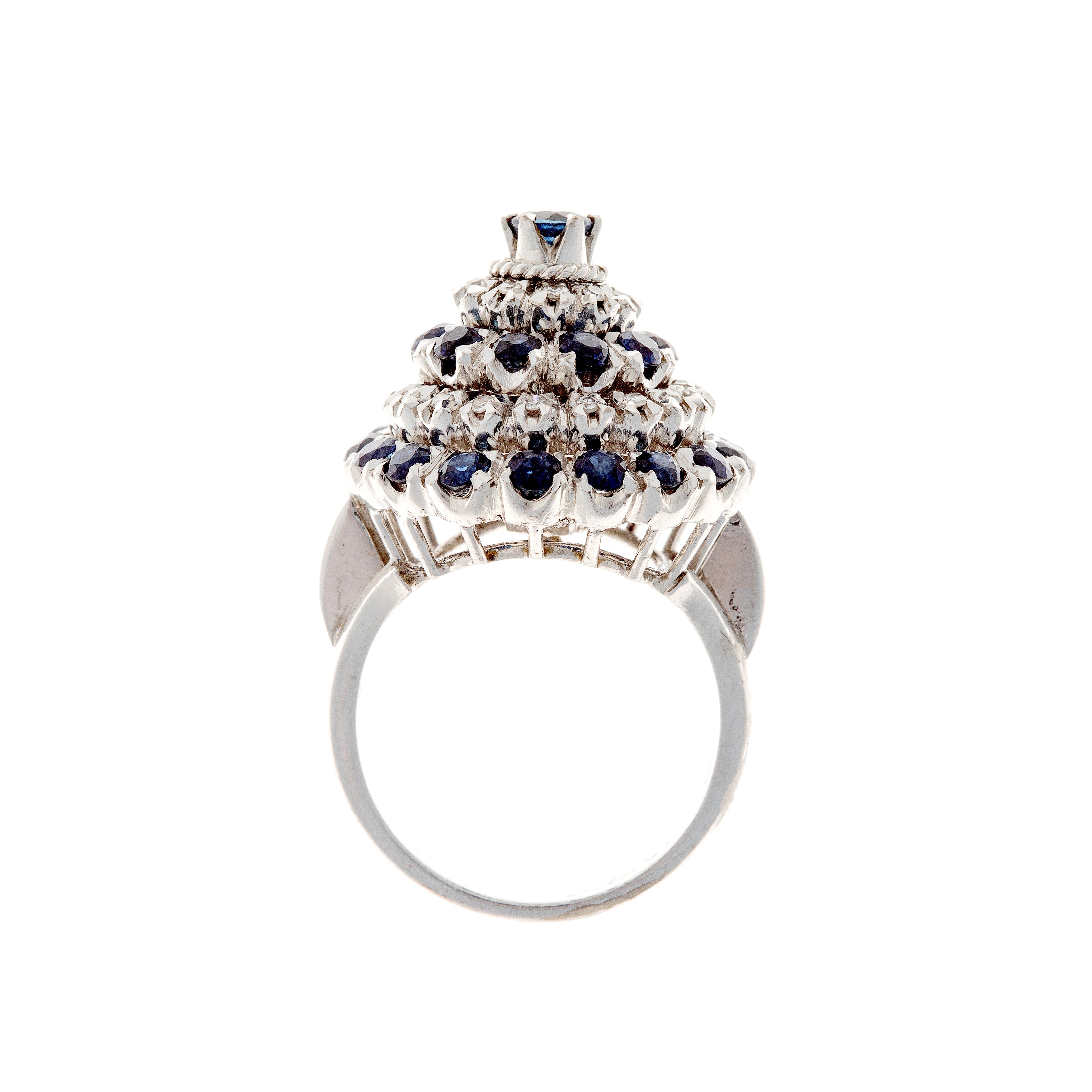 Profile view of white gold ring showcasing multi-level sapphire and diamond cluster setting.