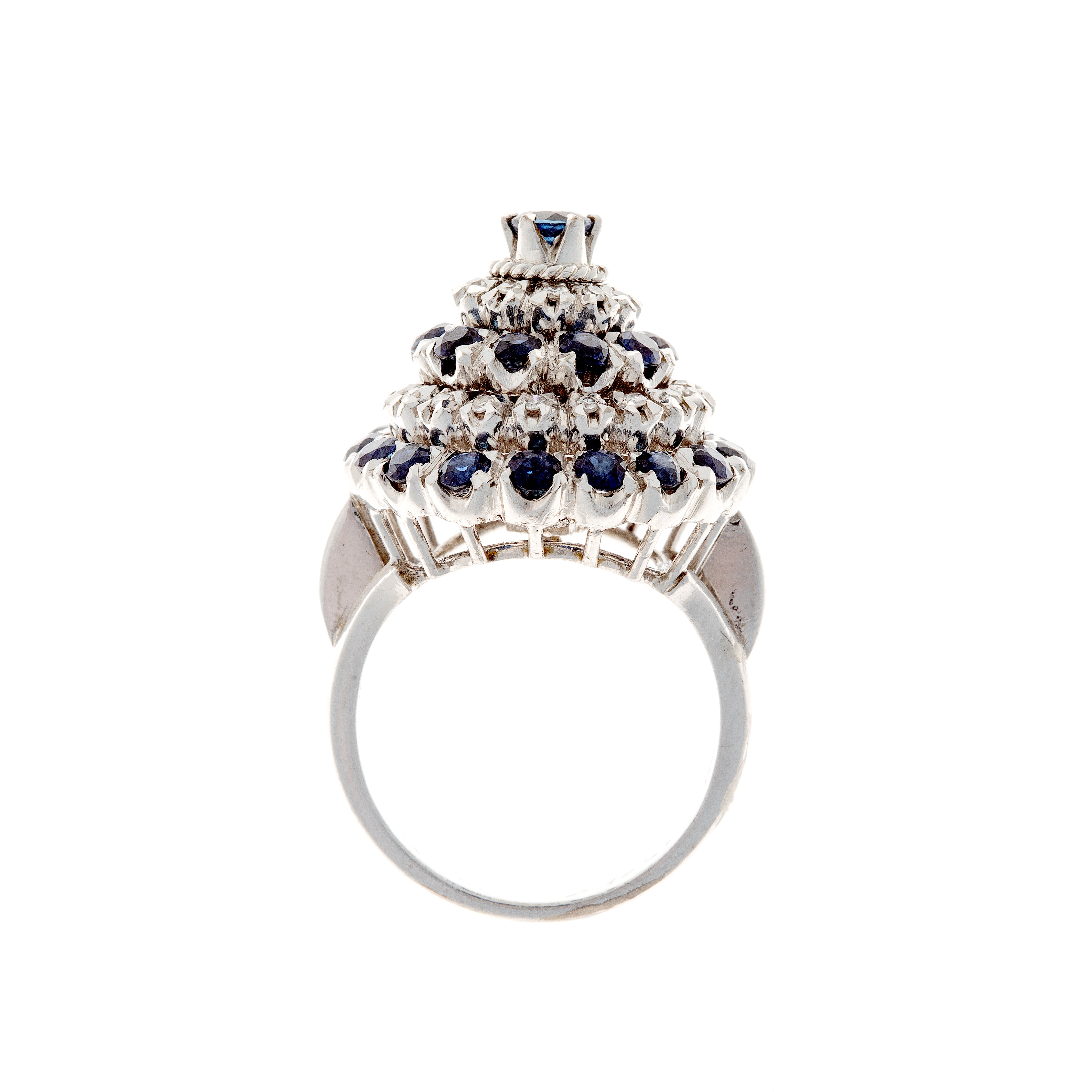 Profile view of white gold ring showcasing multi-level sapphire and diamond cluster setting.