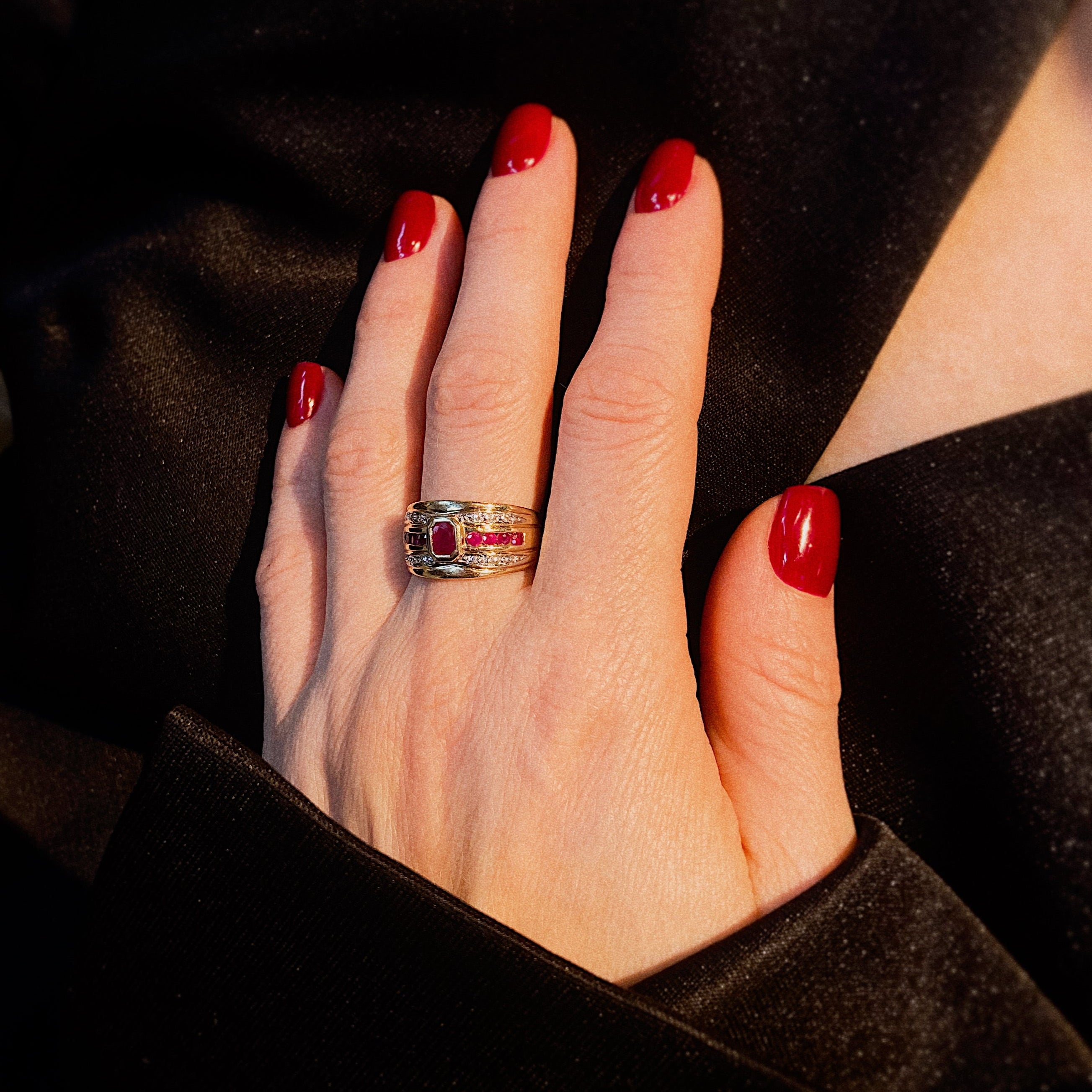 Model wearing the 1980s vintage gold cocktail ring with rubies and diamonds.