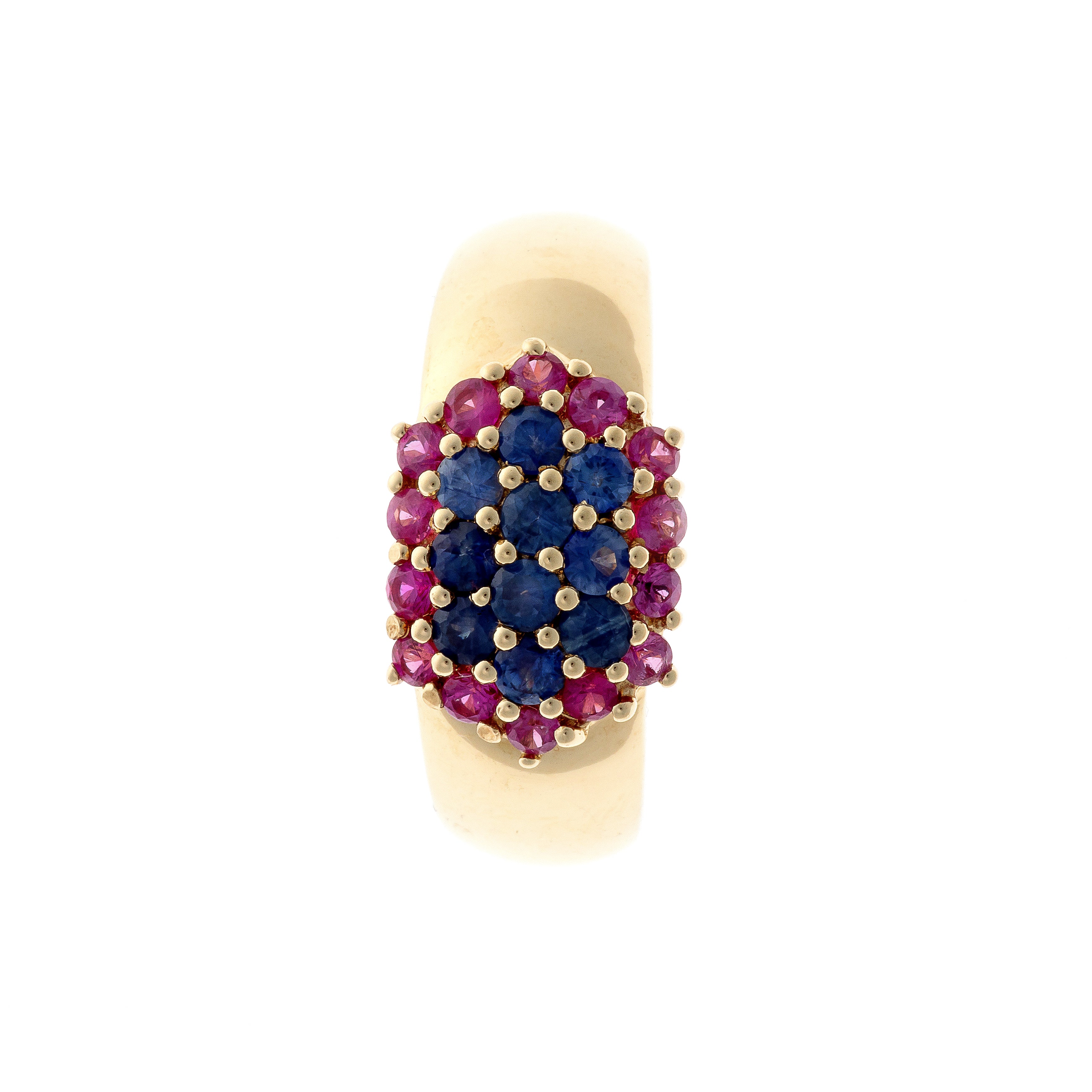 Top view of sapphire and ruby cluster cocktail ring in polished gold.