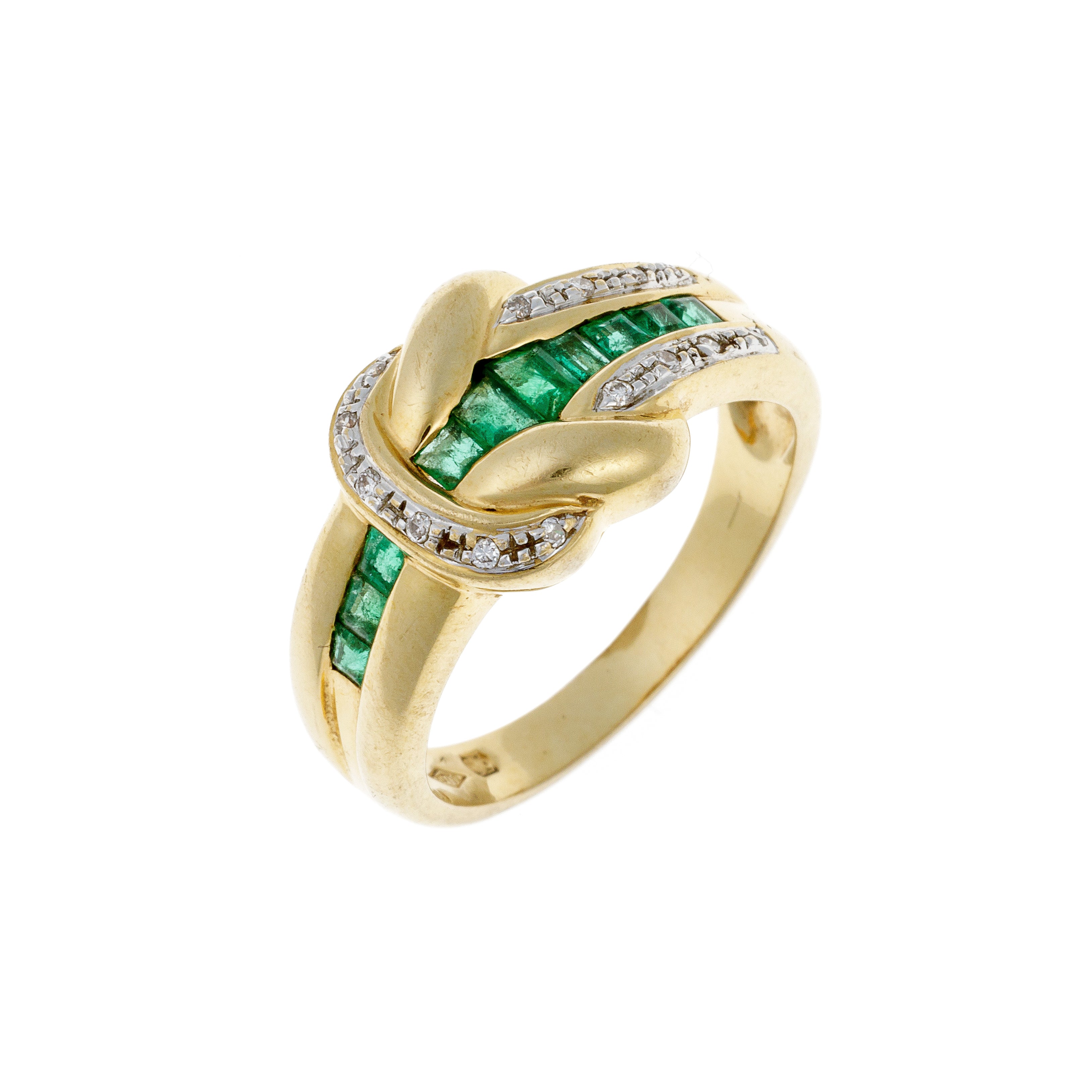 Angled view of contemporary vintage gold cocktail ring with diamonds and emeralds.