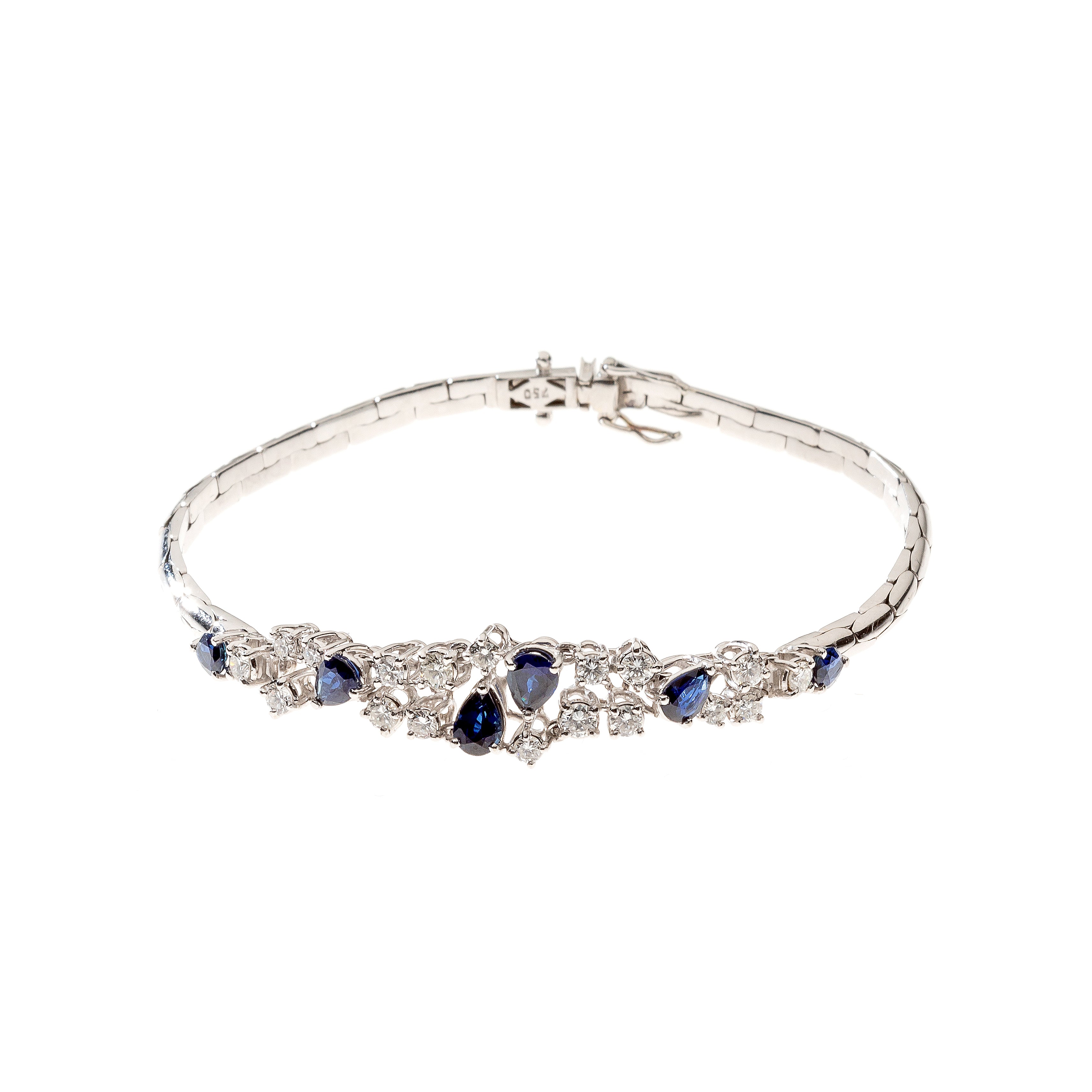 Contemporary vintage white gold bracelet with pear-cut sapphires and diamonds.