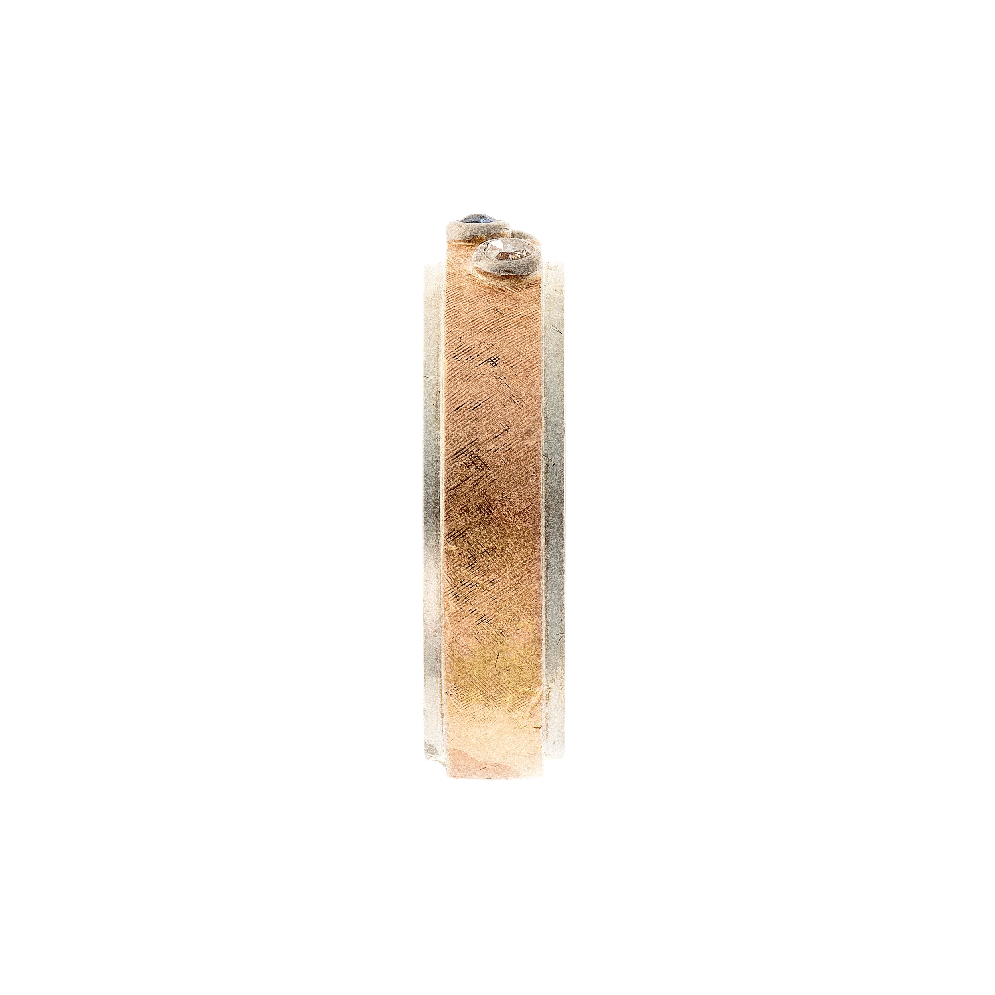 Side of the contemporary vintage two-tone gold band ring with diamonds and sapphires.