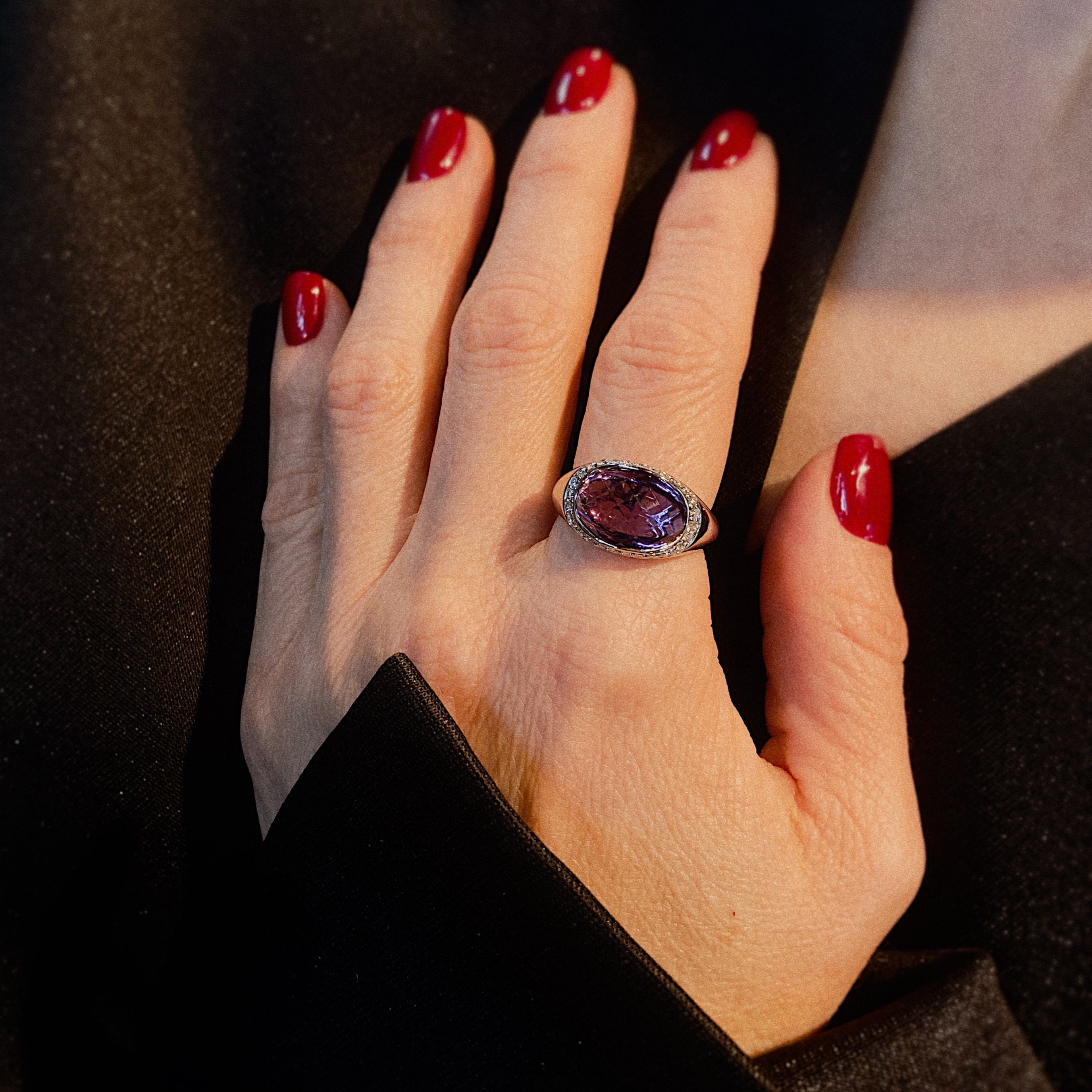 Model wearing the contemporary vintage white gold cocktail ring with diamonds and amethyst.