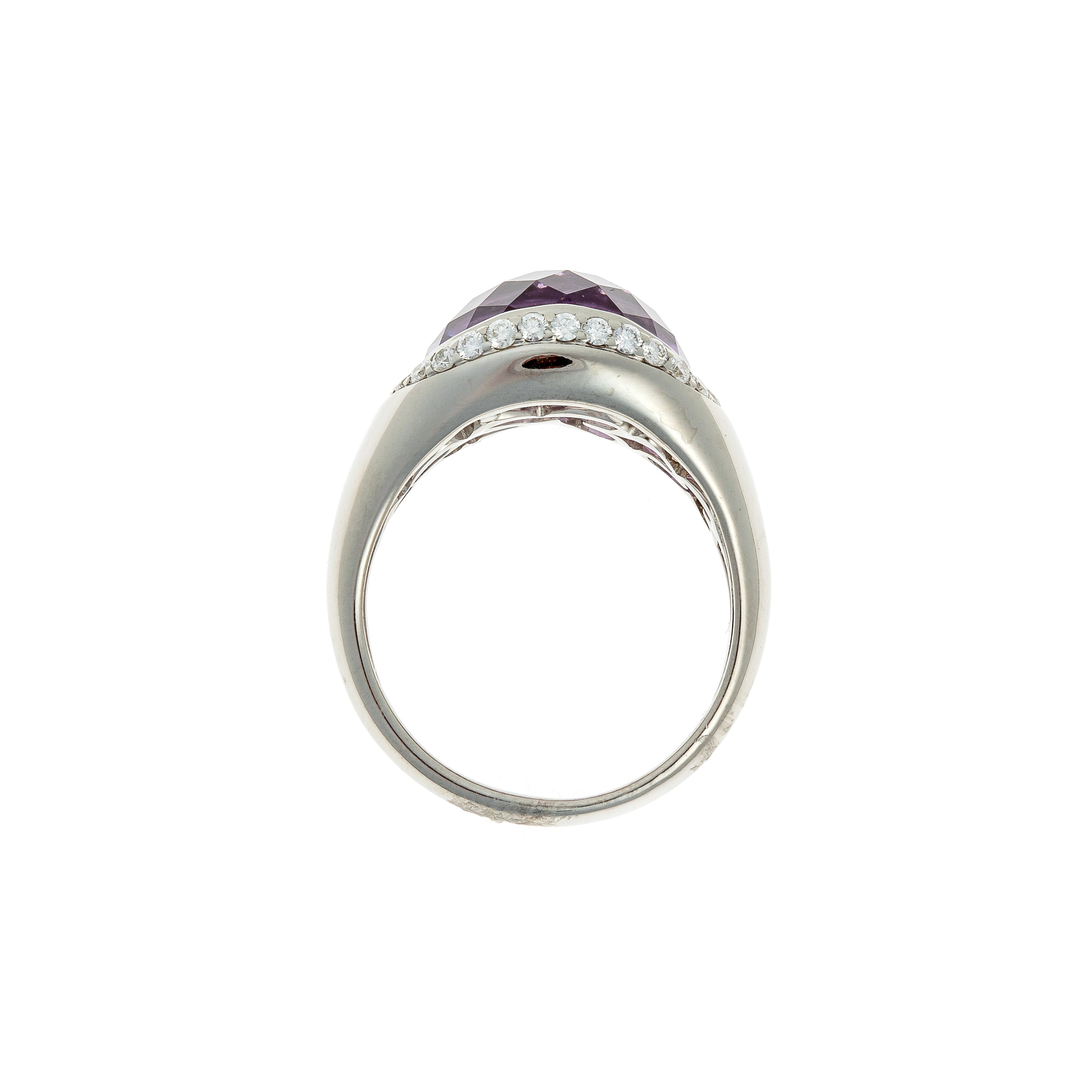 Profile view of sculptural amethyst and diamond setting on the ring in white gold.