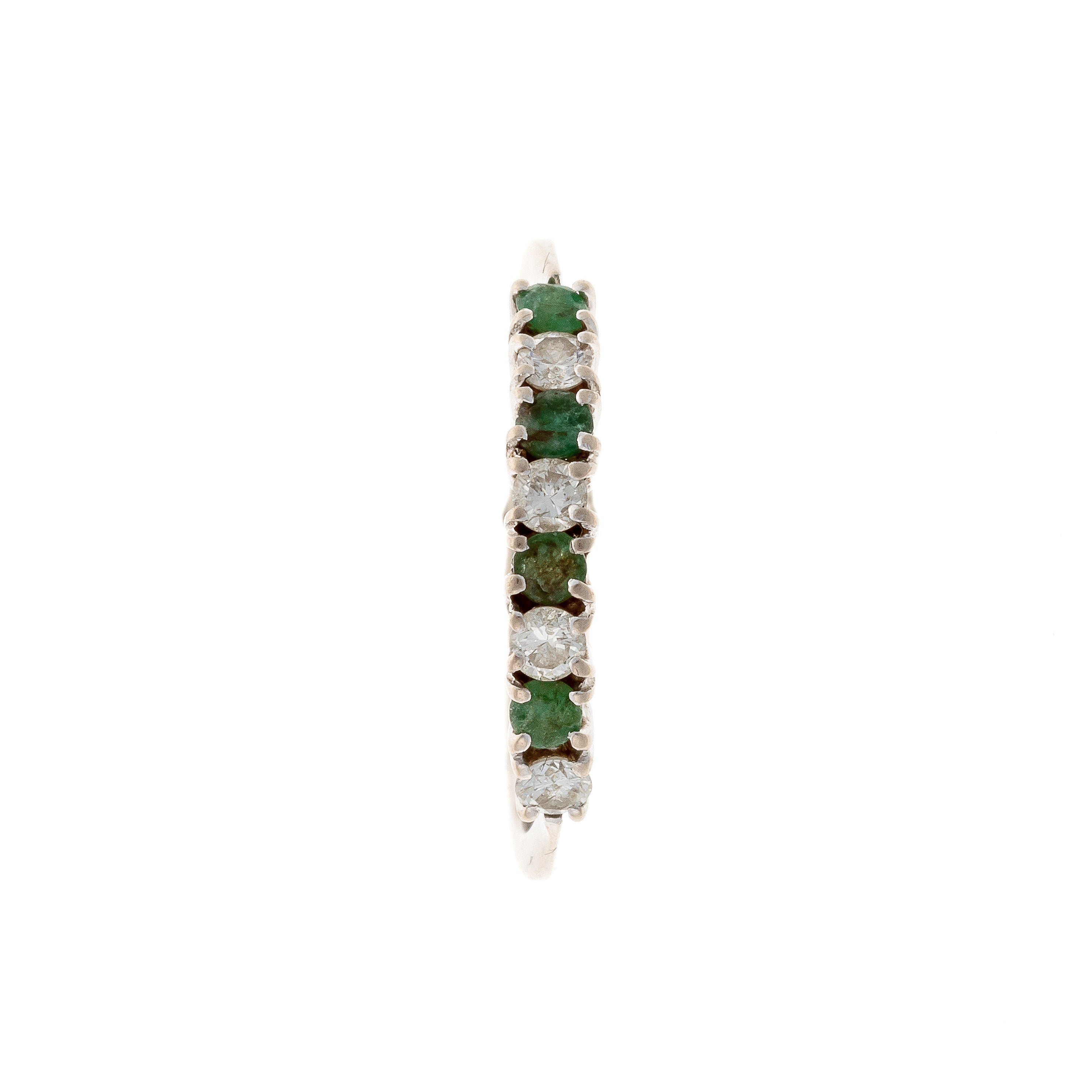 Top of the contemporary vintage white gold emerald and diamond band ring.