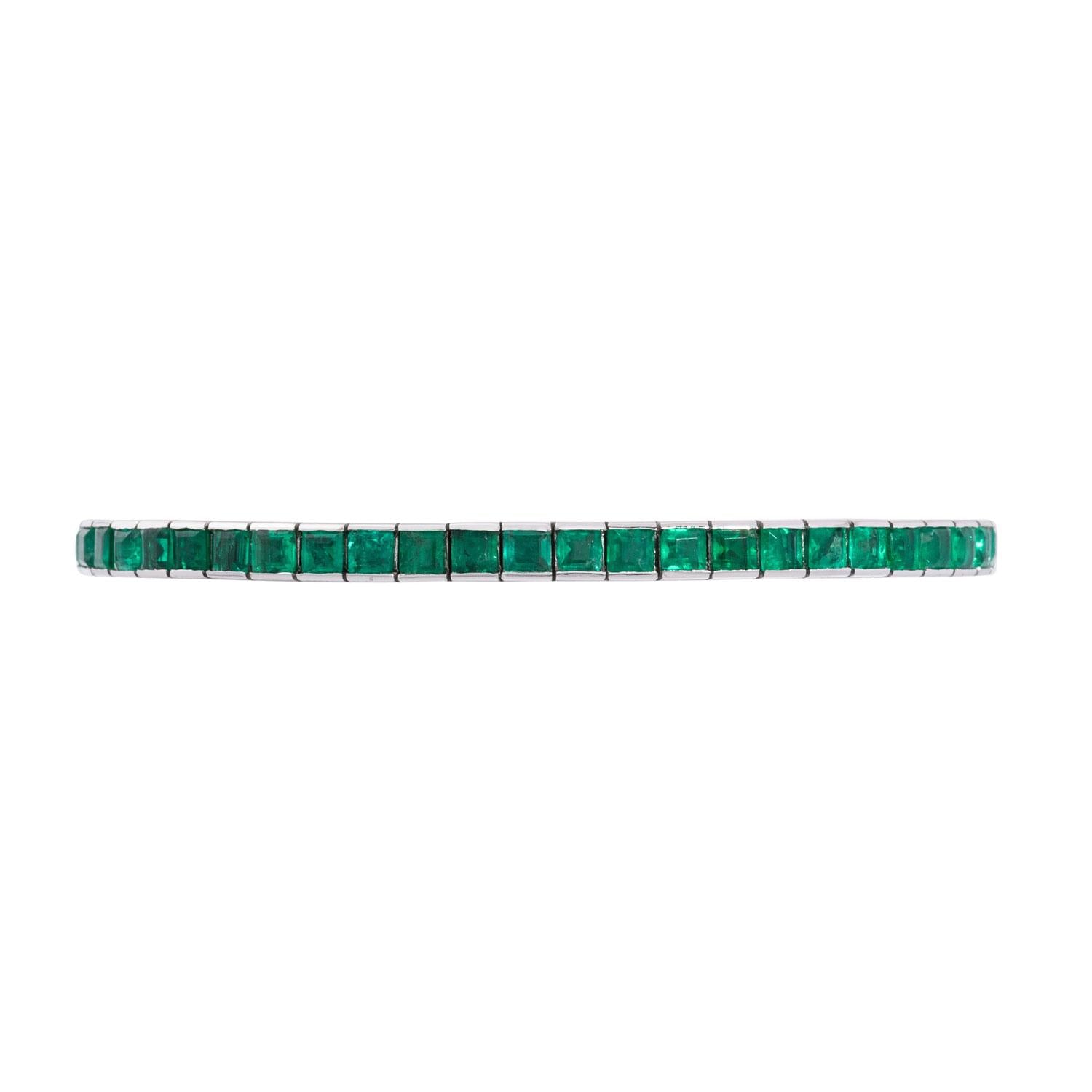 Close-up of square-cut emeralds set in white gold, showcasing geometric articulated tennis bracelet design.