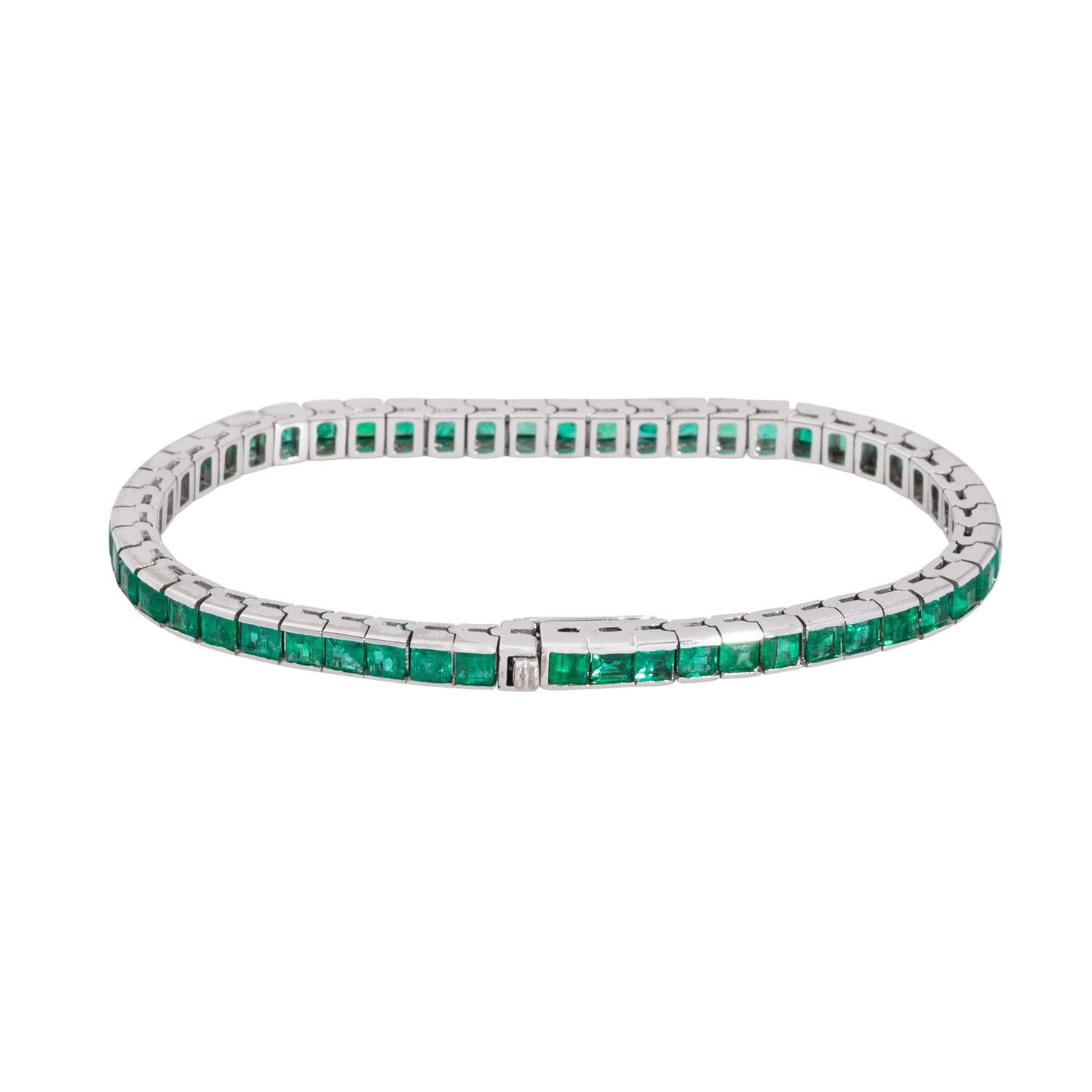 Contemporary vintage white gold tennis bracelet with square-cut emeralds.