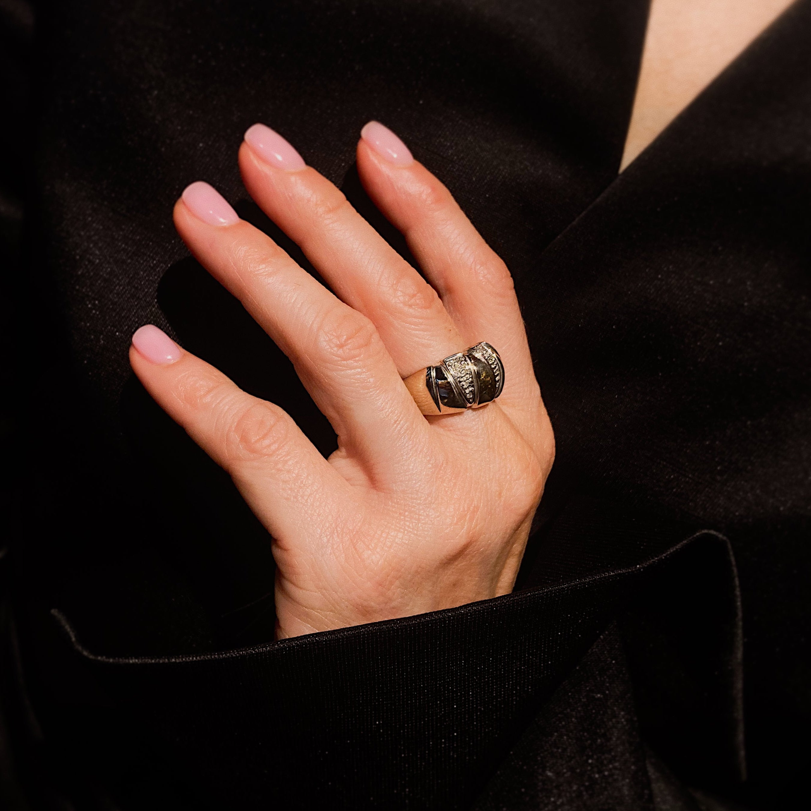 Woman wearing the contemporary vintage white gold ribbed dome diamond band ring.