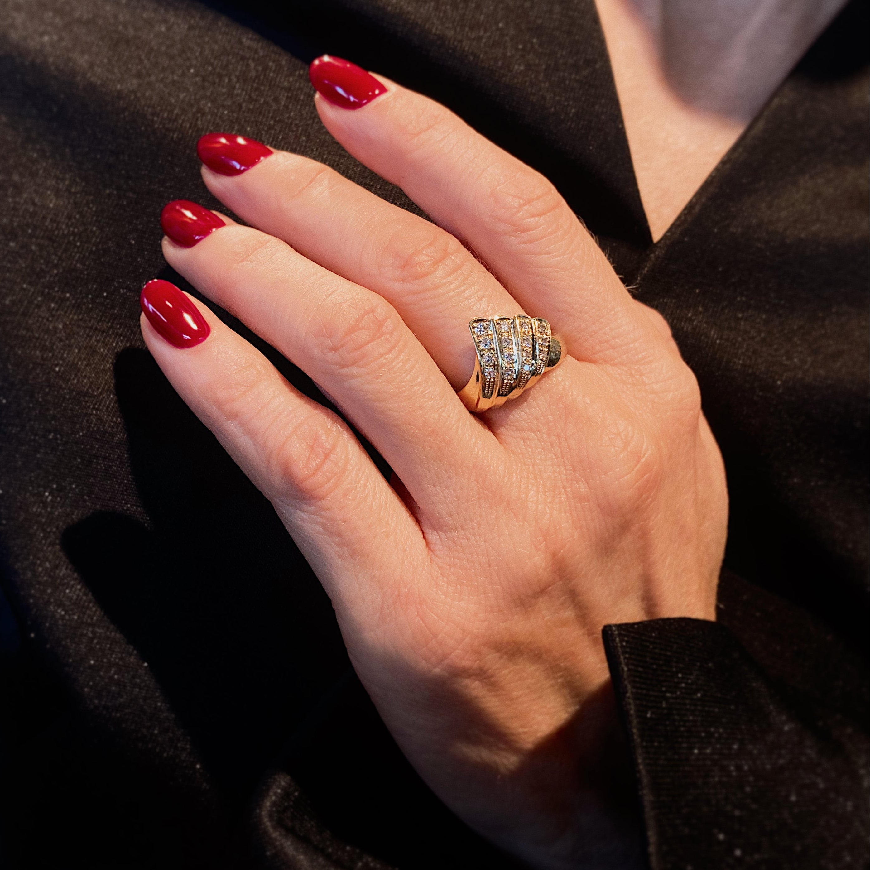 Woman wearing the contemporary vintage yellow gold tiered diamond cocktail ring.