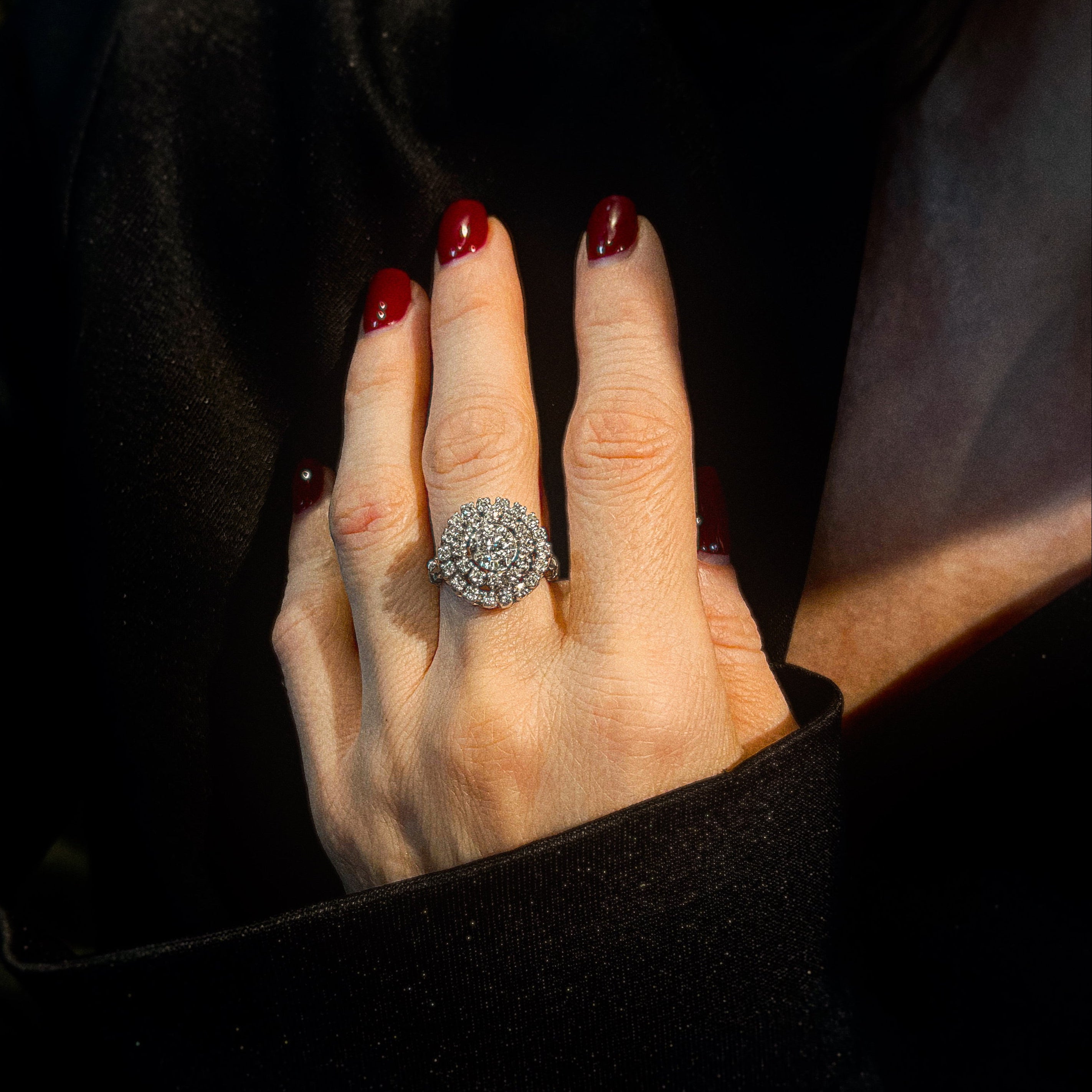 Model wearing the vintage white gold pompadour diamond halo cocktail ring.