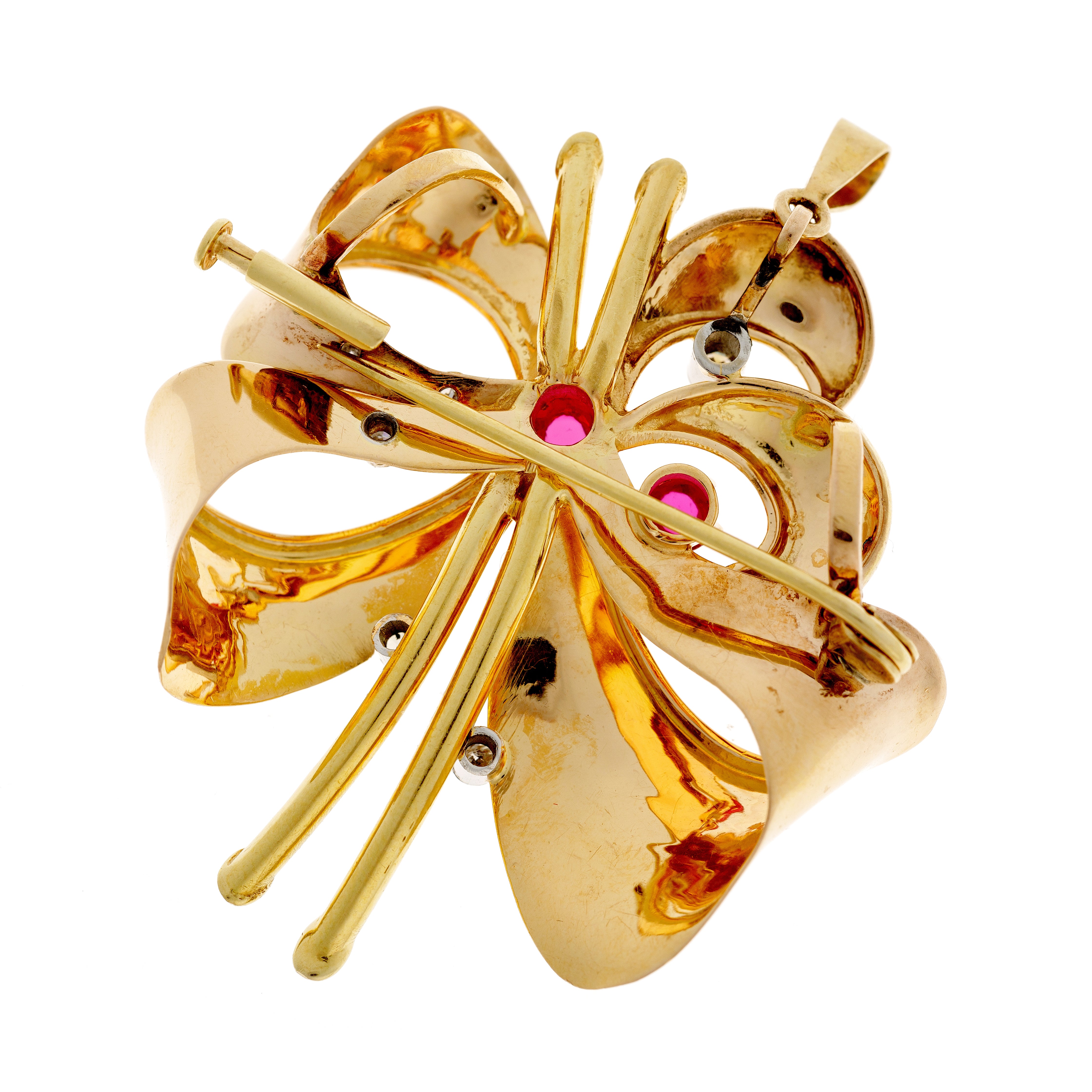 Estate gold brooch pendant with intricate openwork design, featuring rubies, diamonds, and a secure pin clasp