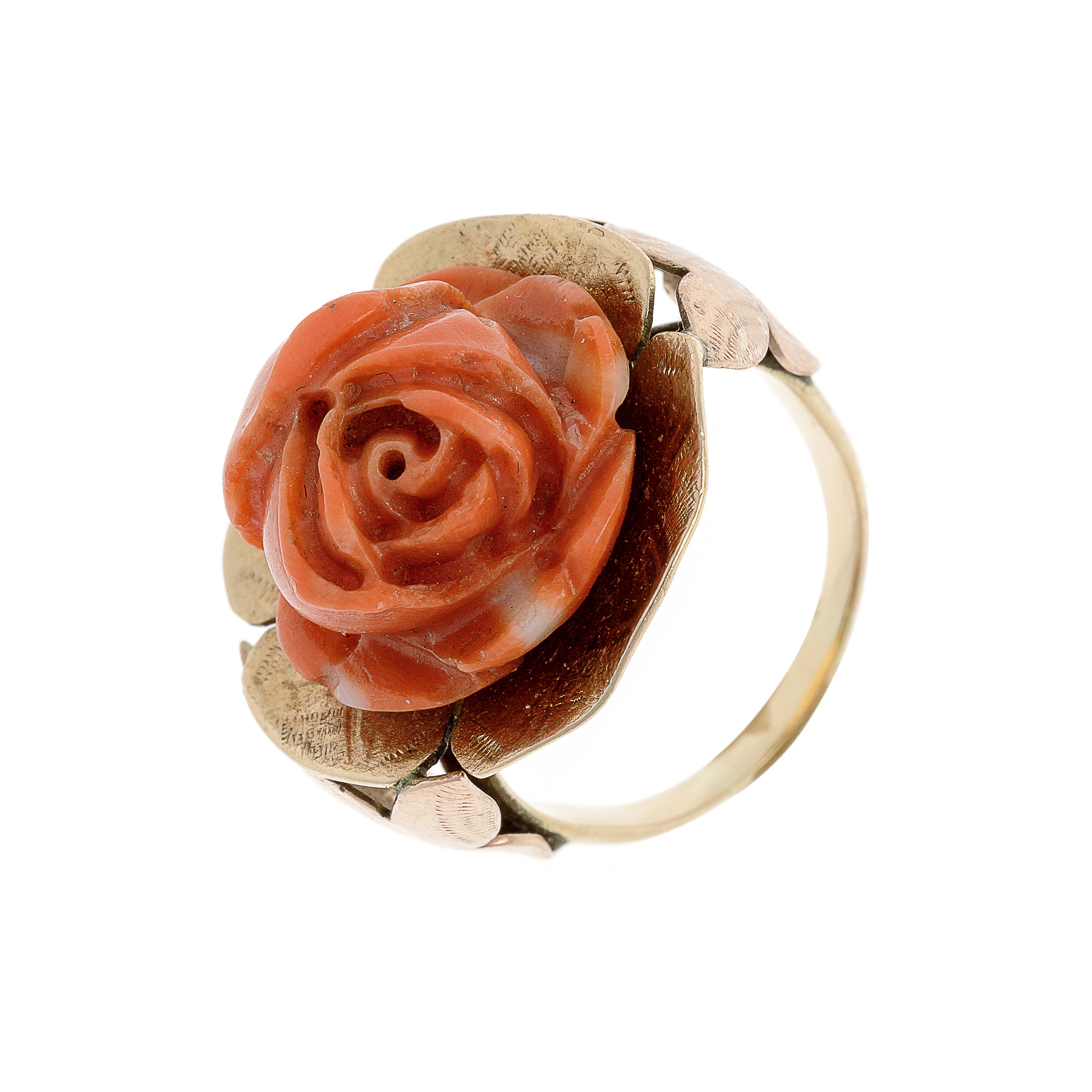 Angled side view of the estate coral rose ring, showcasing its delicate carved petals and gold band.