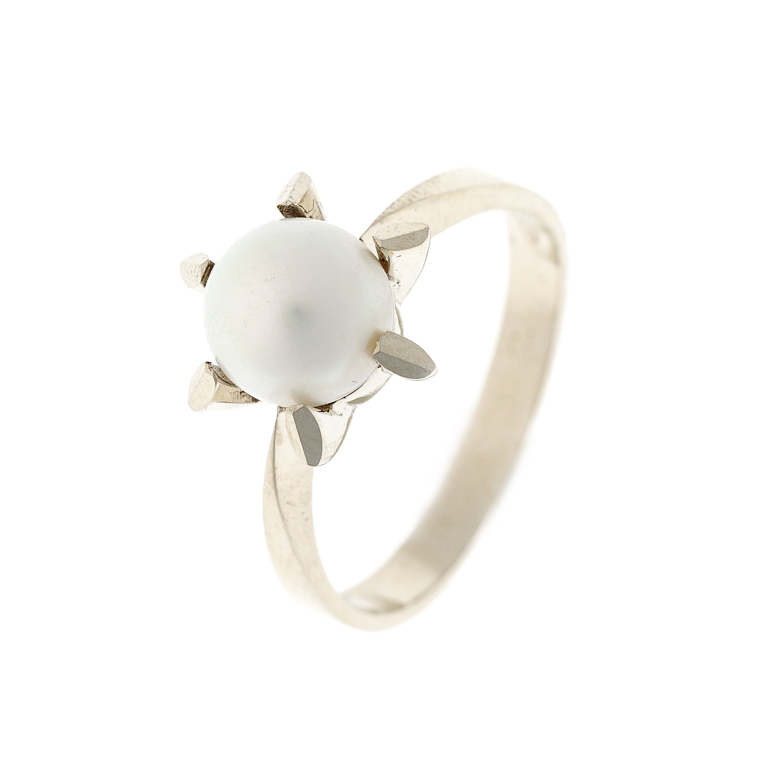 Angled side view of the estate pearl solitaire ring, showcasing its sleek white gold band and bold prong setting.