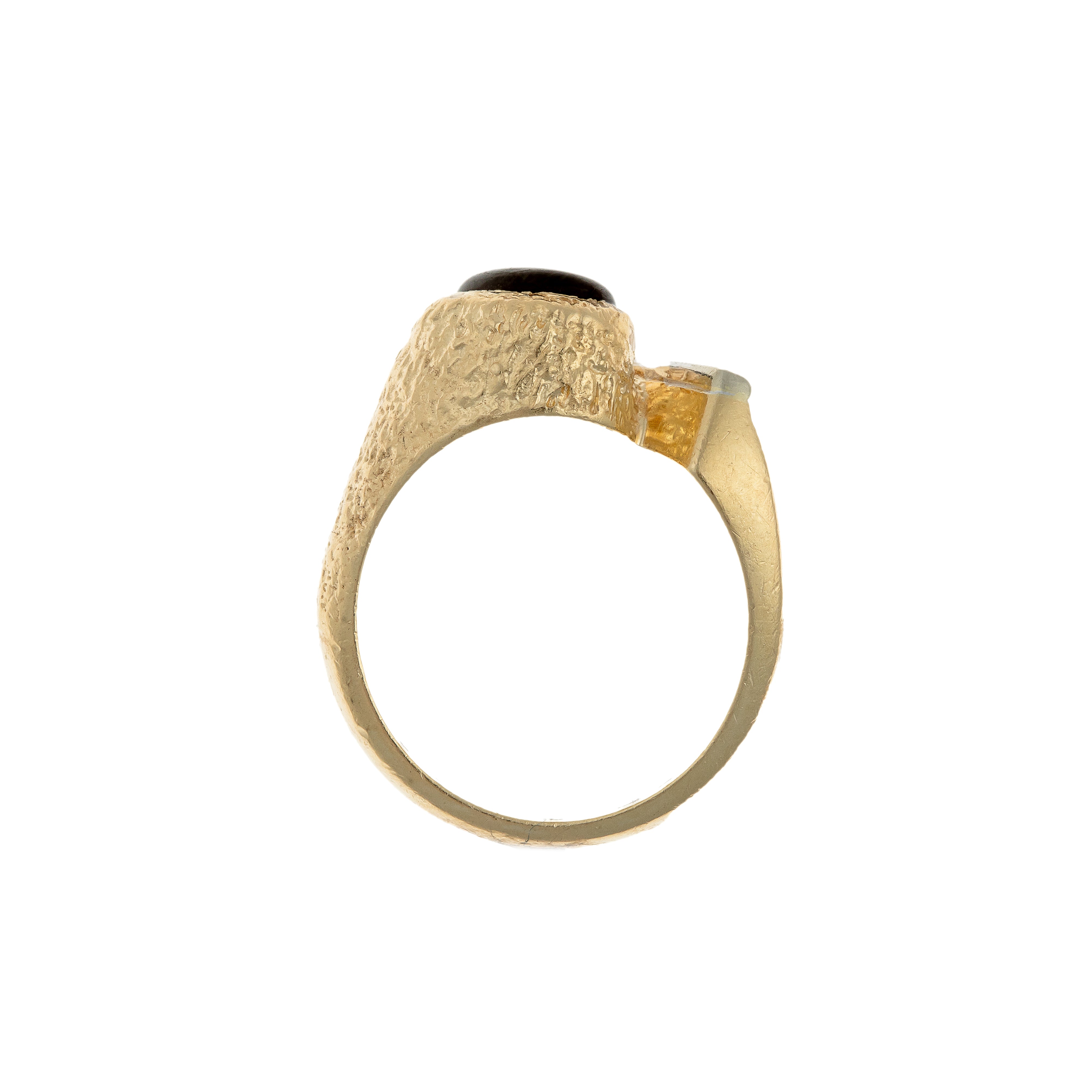 Profile view of a 1970s German star sapphire and diamond ring with an asymmetric gold setting.