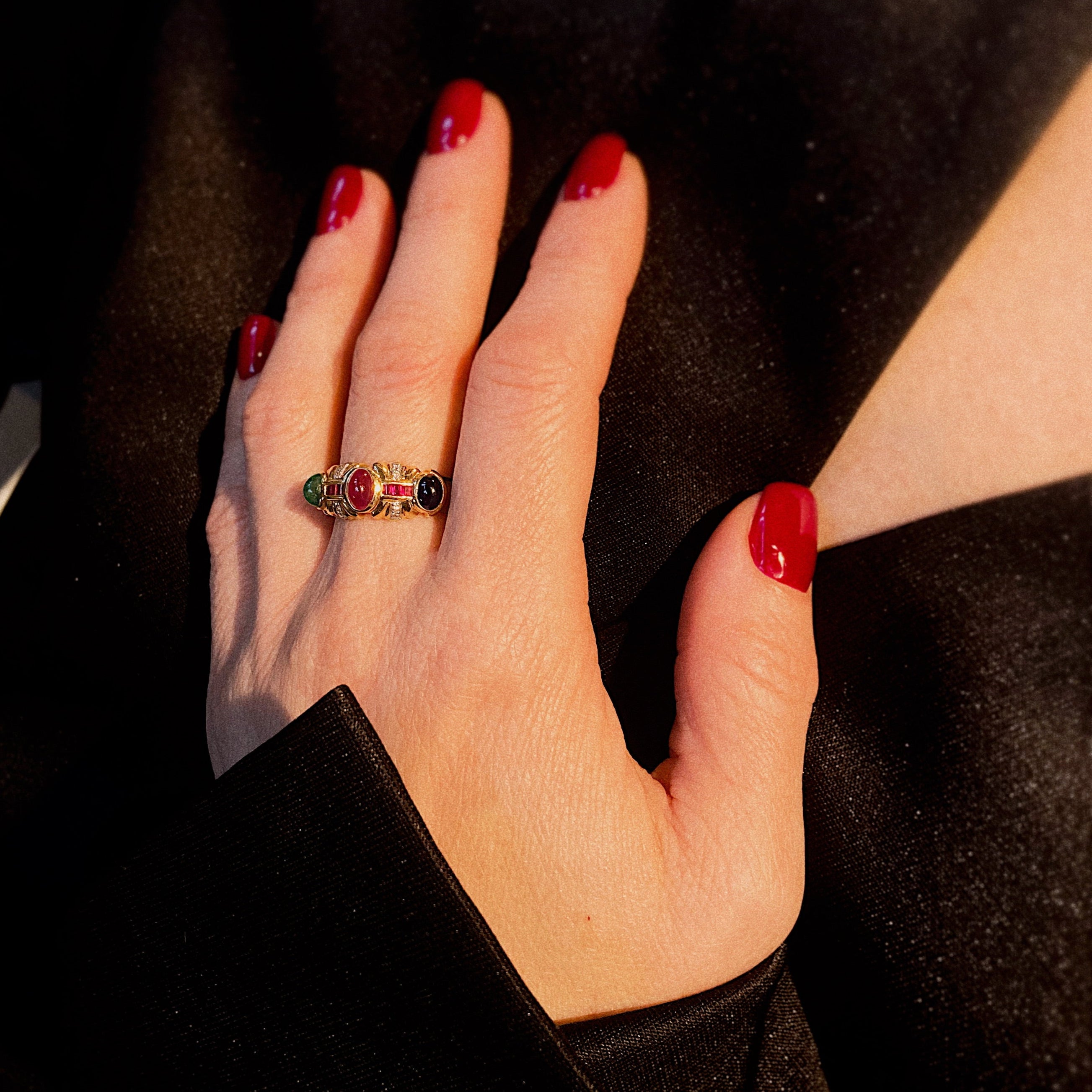 Model wearing the vintage gold cocktail ring with colored gemstone cabochons.