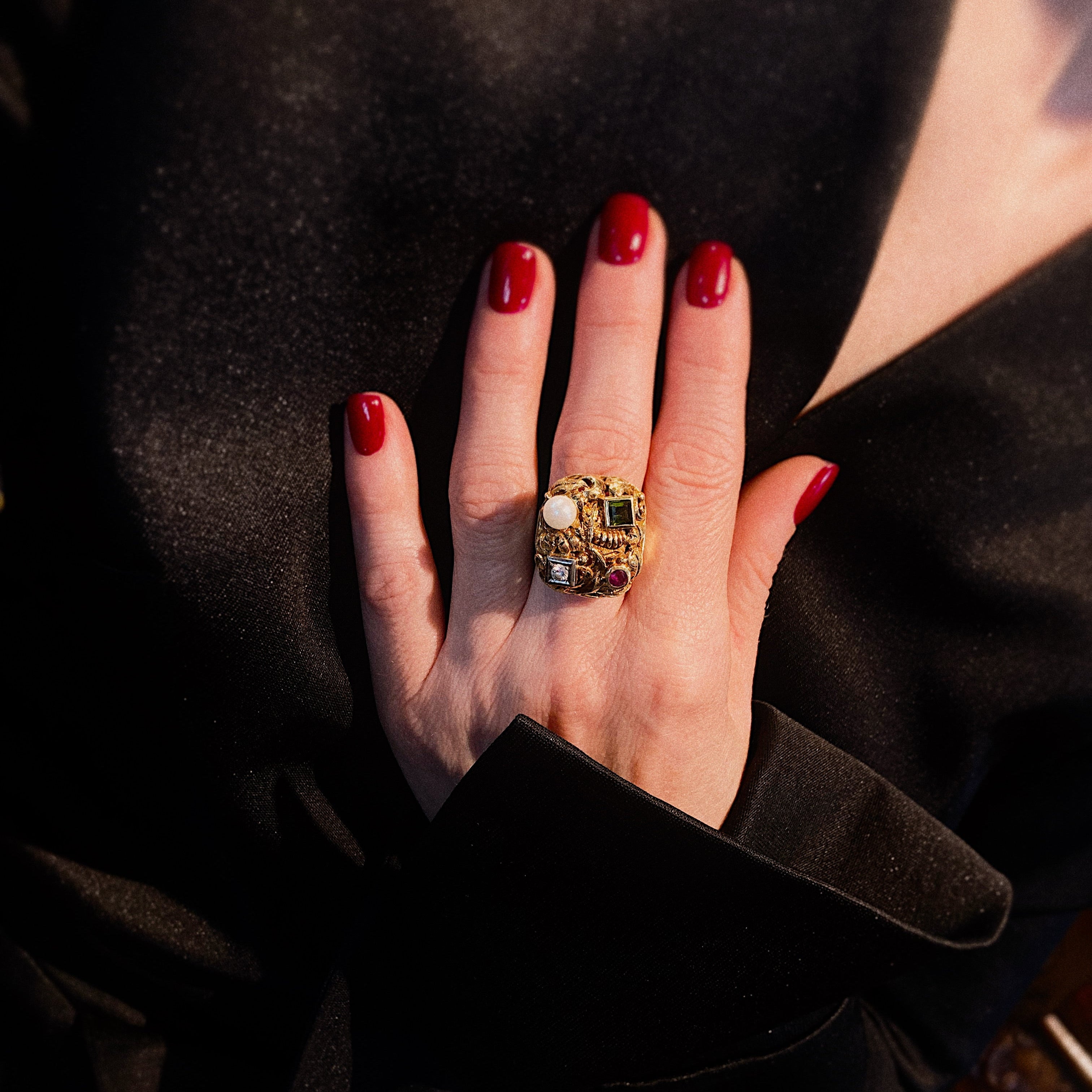Model wearing the vintage gold cocktail ring with diamond, ruby, pearl and tourmaline.