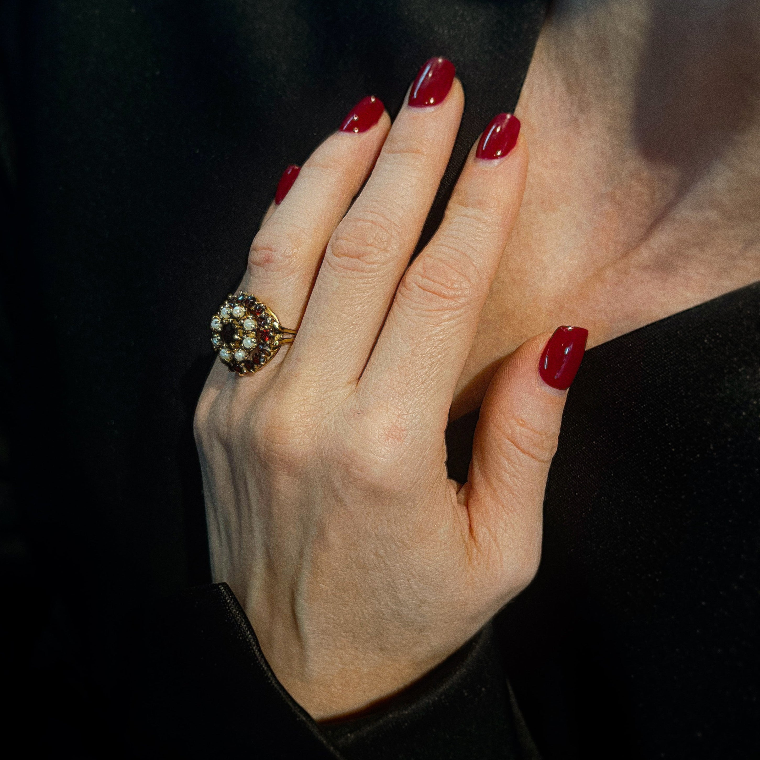 Model wearing the vintage gold cocktail ring with almandine garnets and cultured pearls.
