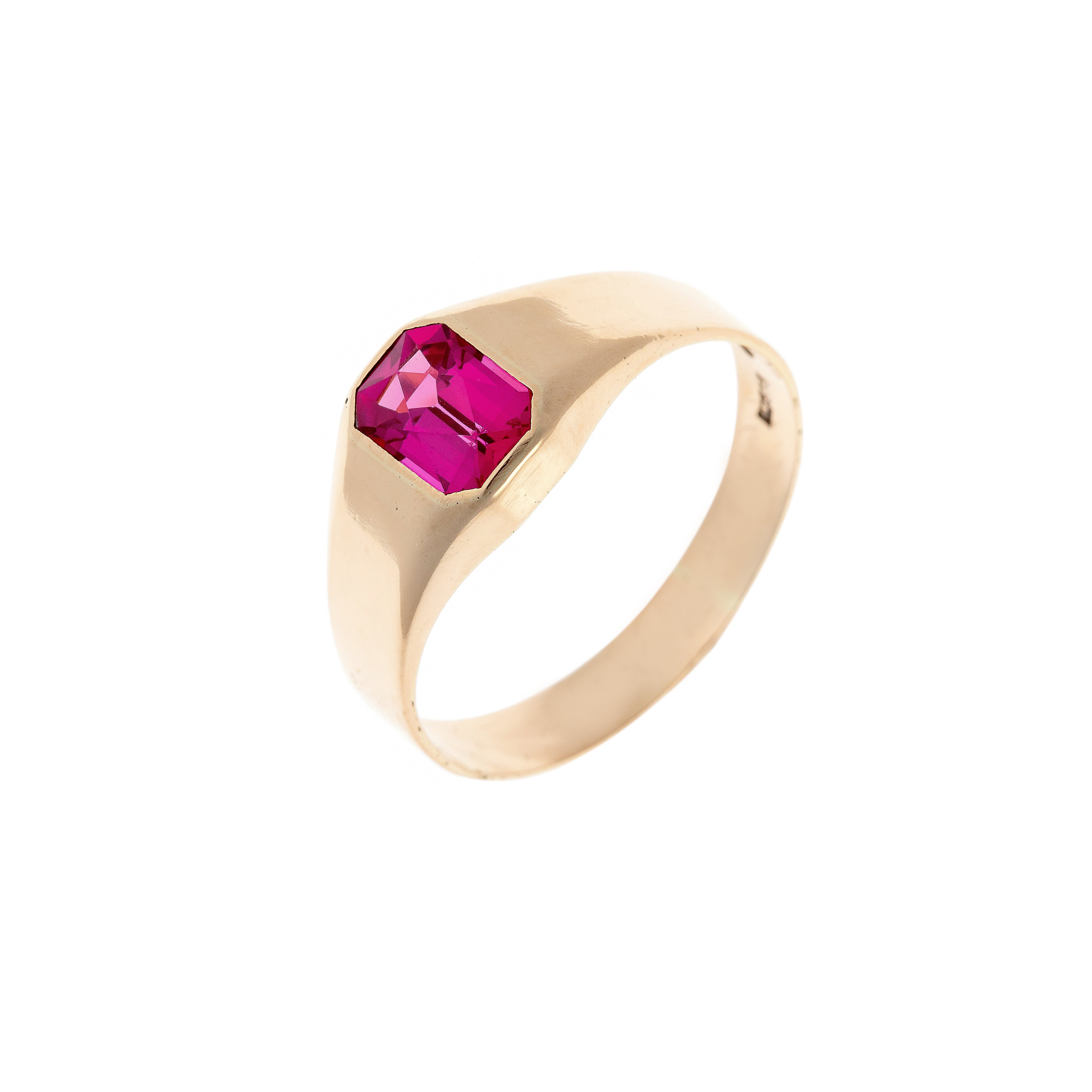 Mid-century vintage 14K gold signet ring featuring an emerald-cut lab-grown ruby, photographed at an angle.