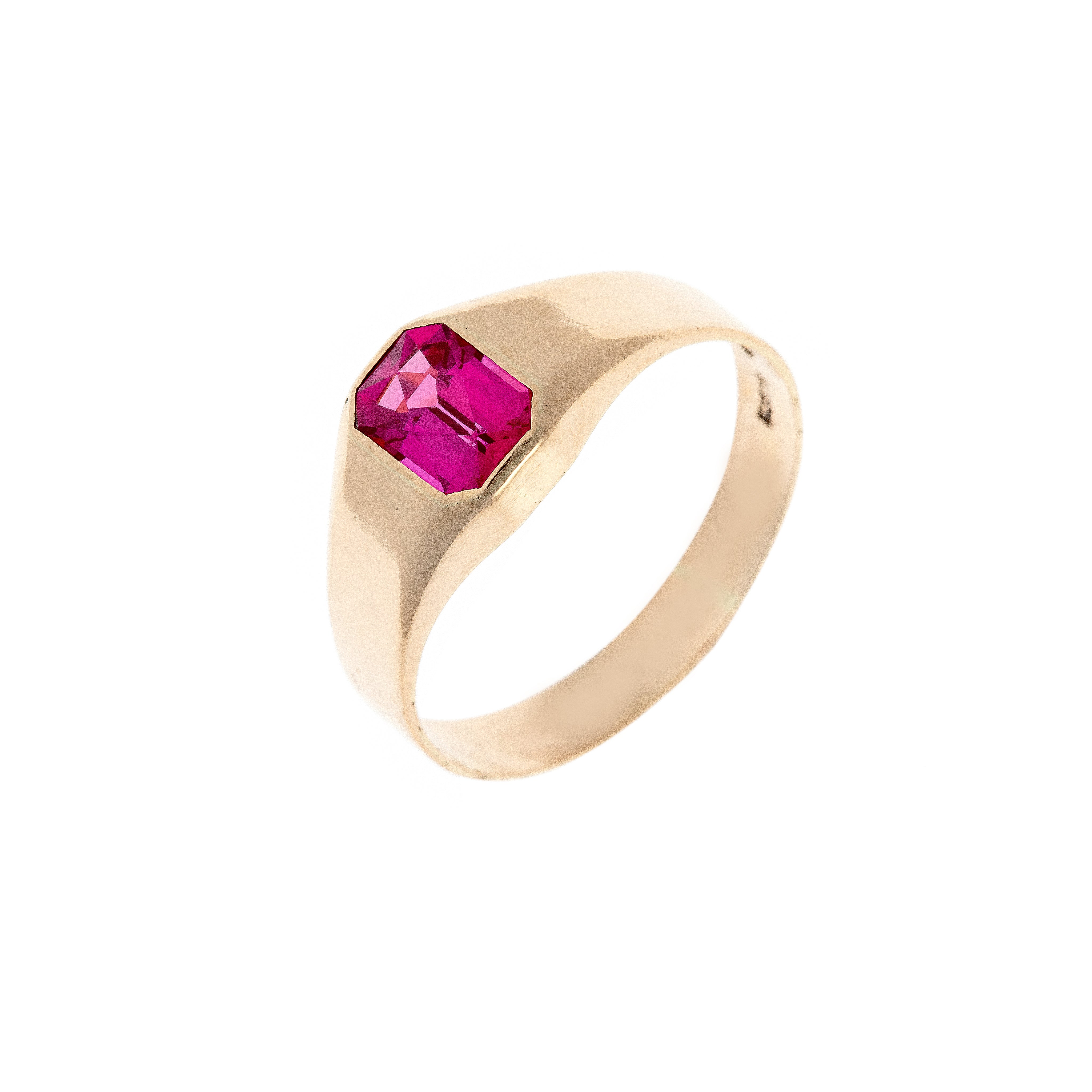 Mid-century vintage 14K gold signet ring featuring an emerald-cut lab-grown ruby, photographed at an angle.