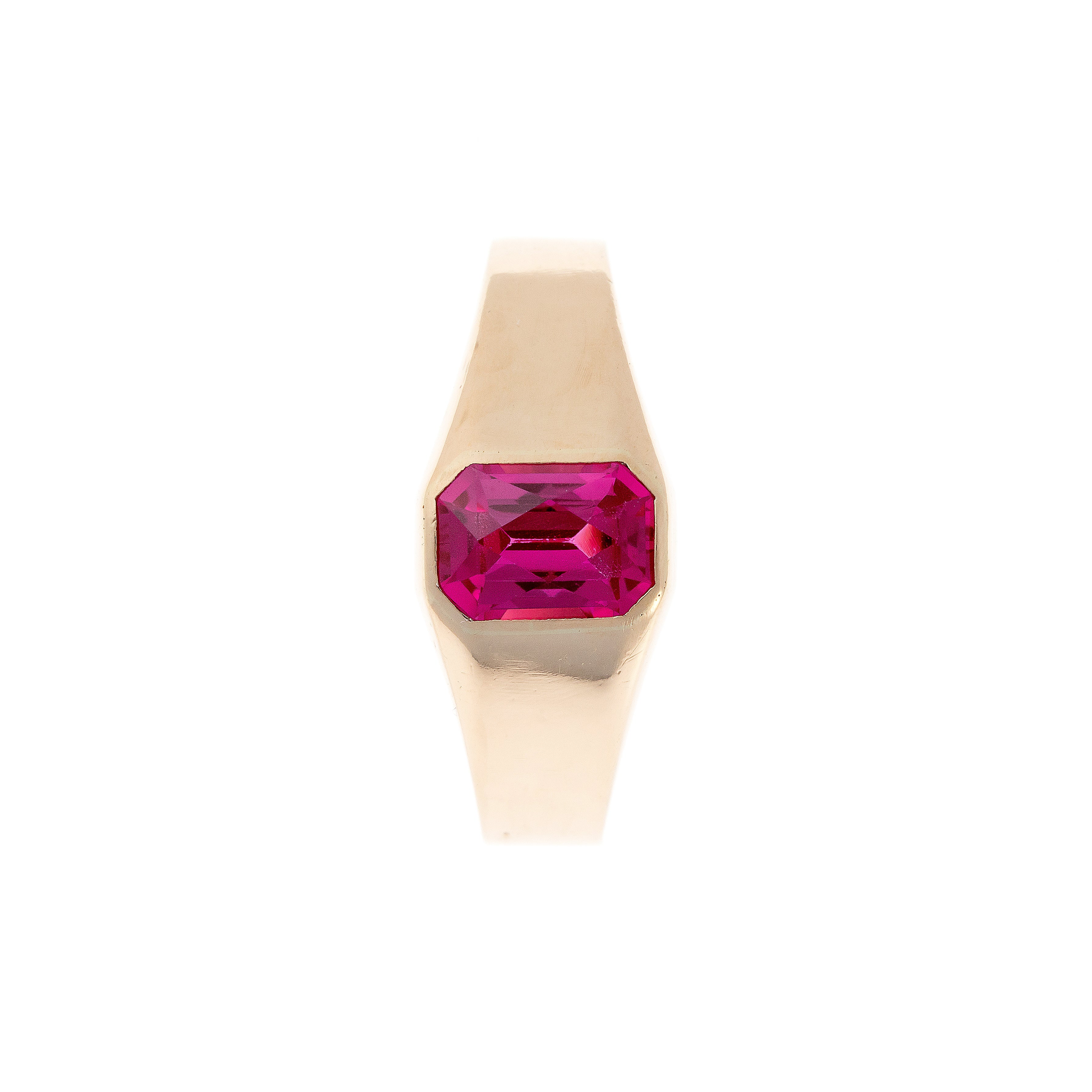 Top-down view of a mid-century 14K gold signet ring with a bezel-set synthetic ruby, showcasing its clean, geometric design.