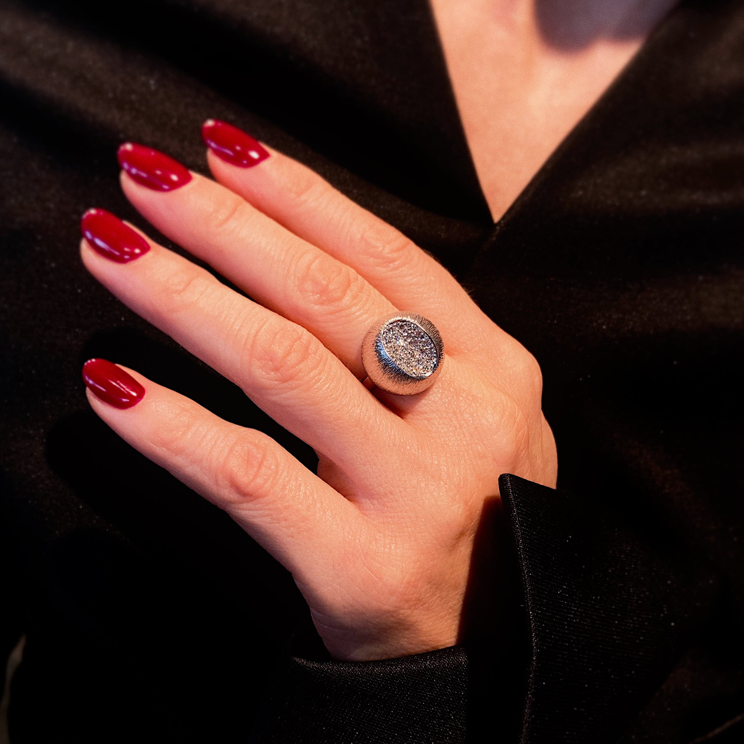 Woman wearing the Mid-Century white gold pavé diamond dome cocktail ring. 