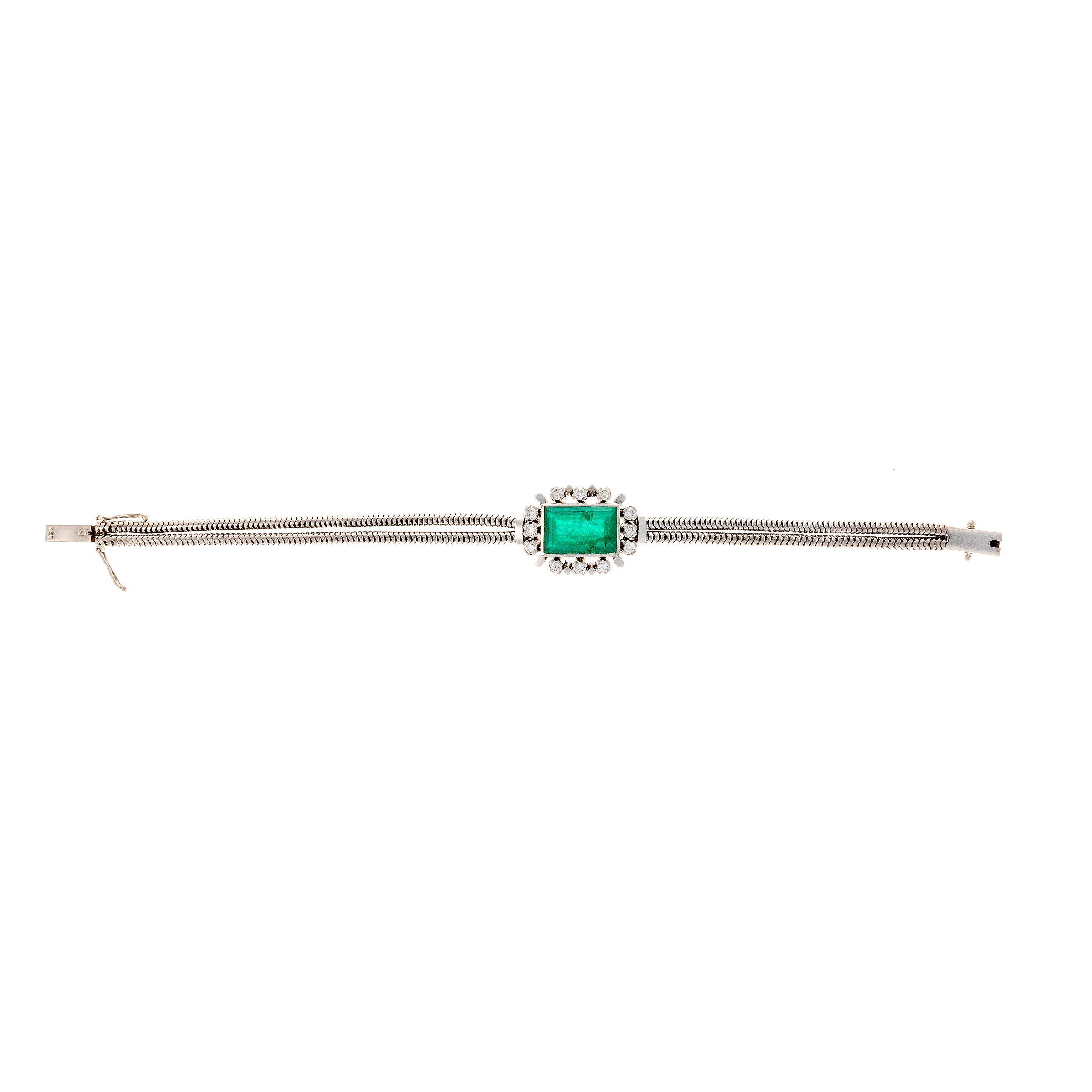 Flatlay shot of the vintage mid-century French white gold bracelet with lab-grown emerald centerpiece and diamonds.