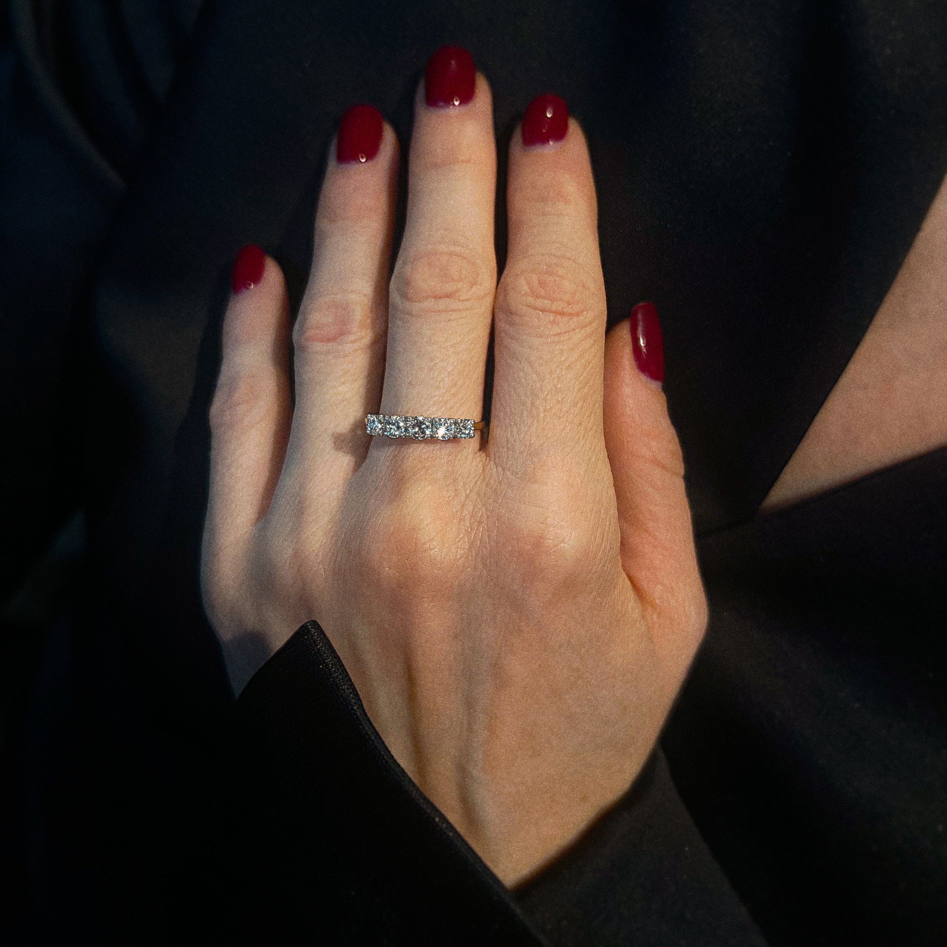 Model wearing the mid-century gold five-stone diamond ring.
