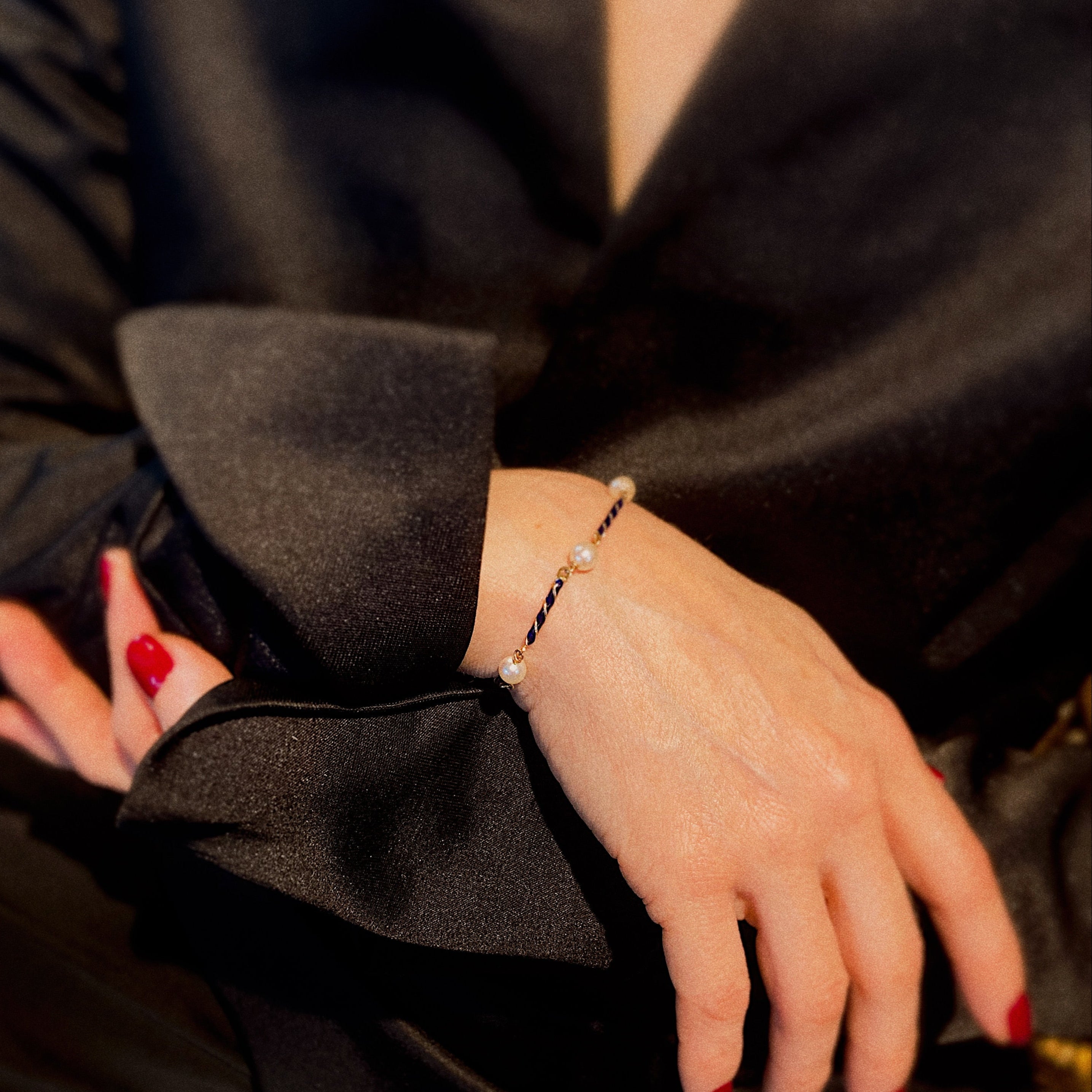 Model wearing the vintage old bracelet with enamel and akoya pearls.