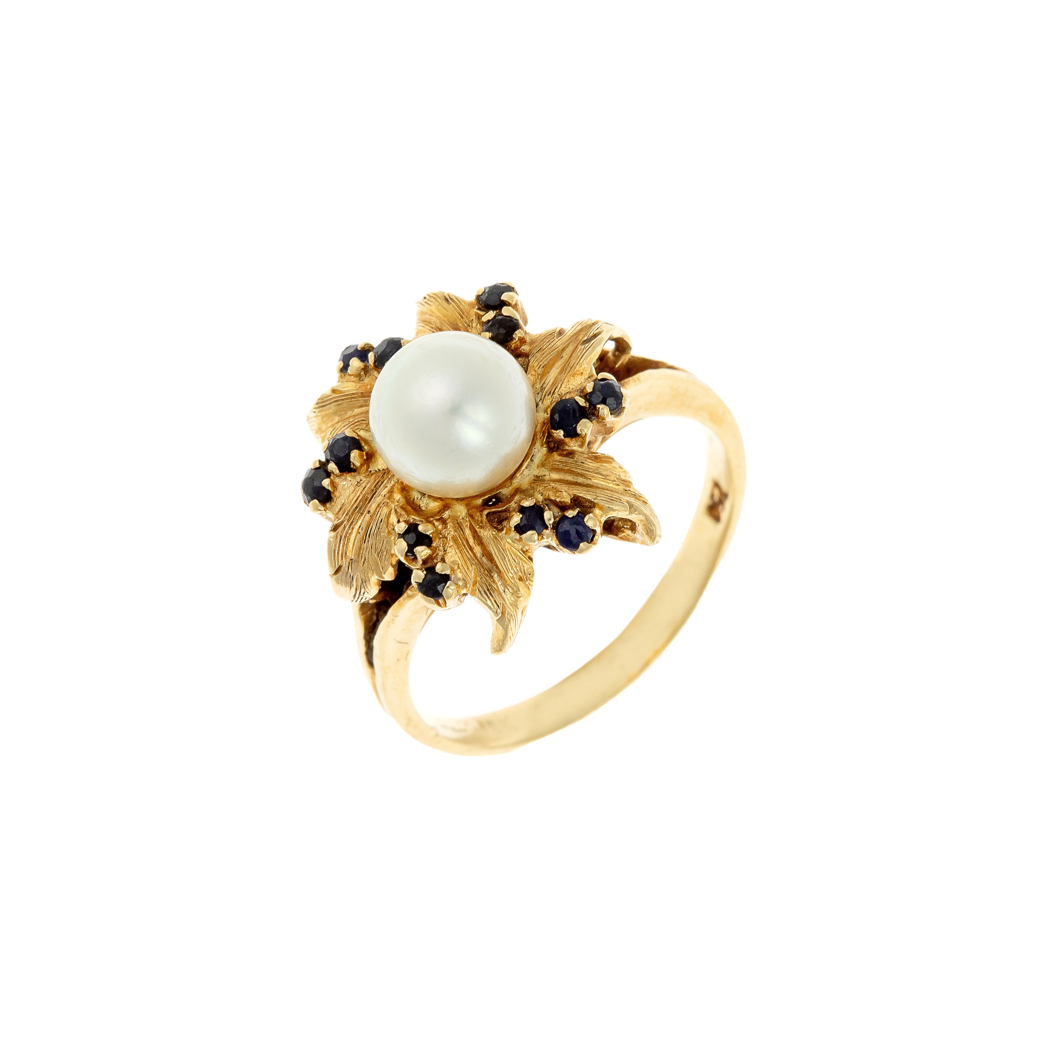 Angled view of Mid-Century French gold cocktail ring with pearl and sapphires in floral design.