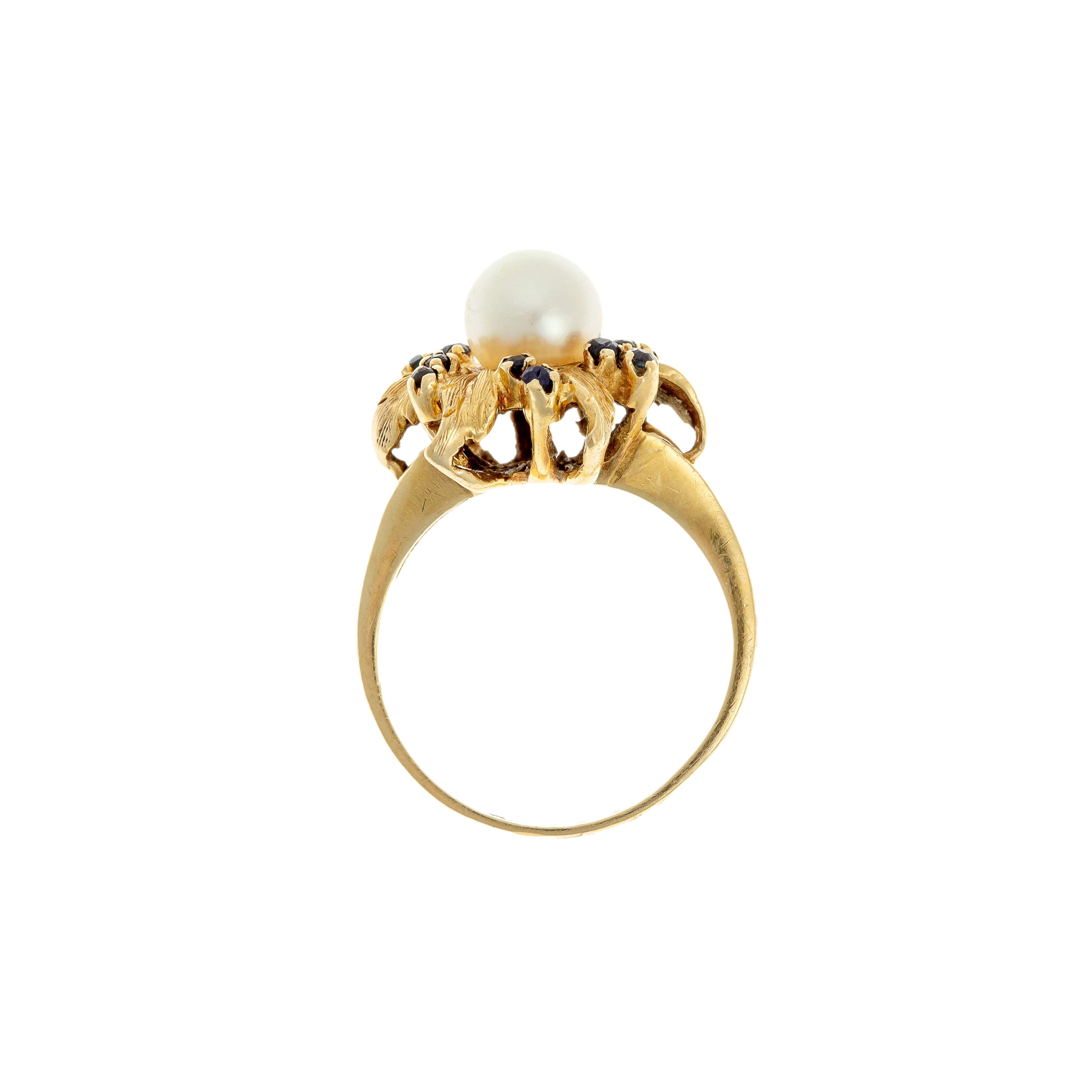 Profile view of raised floral ring gallery with cultured pearl and sapphires.