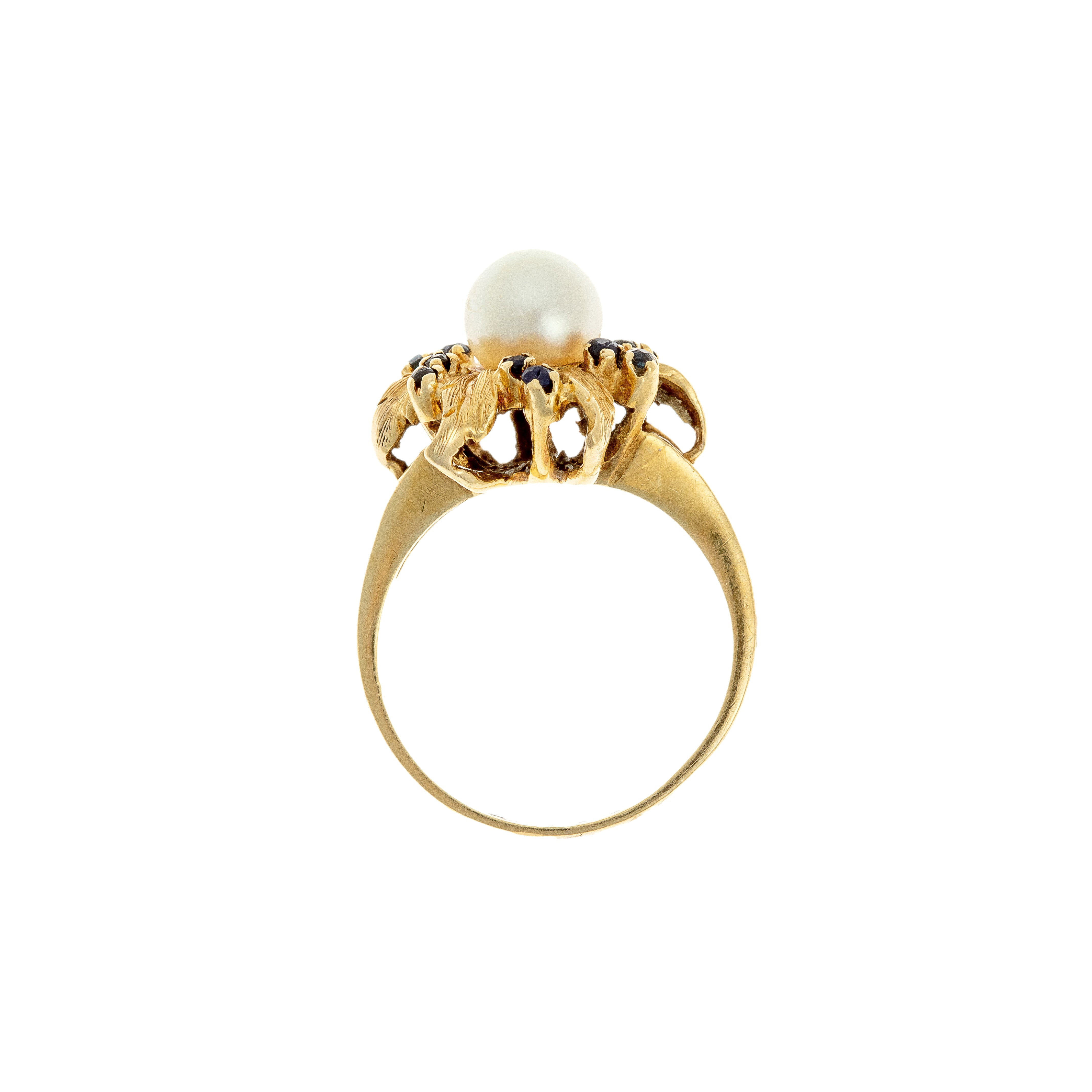 Profile view of raised floral ring gallery with cultured pearl and sapphires.