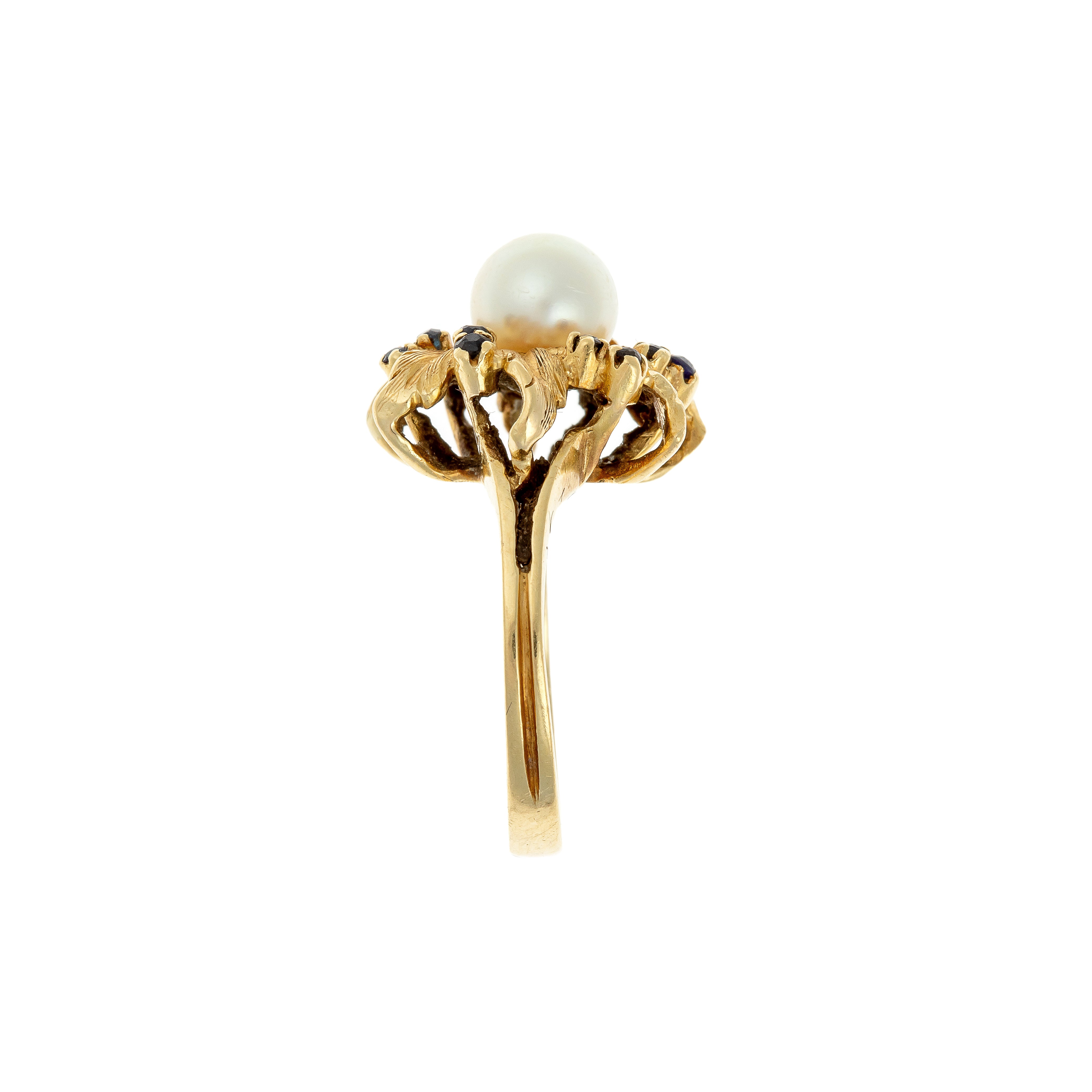 Side view of French 18K gold ring showing sculpted leaf design with pearl and sapphires.