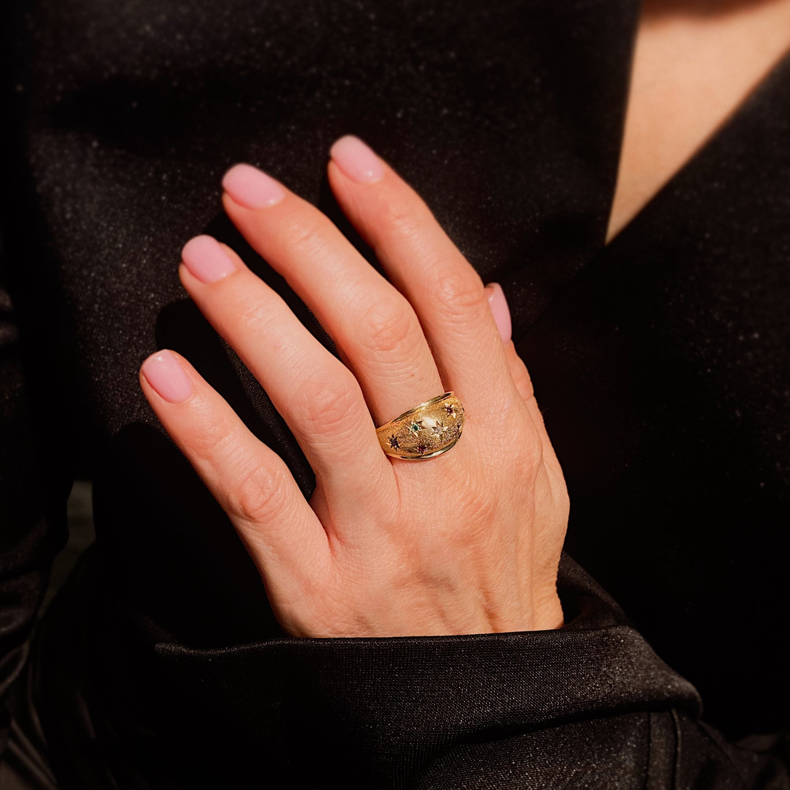 Woman wearing the vintage Mid-Century or sablé multi-gem star-set dome cocktail ring.