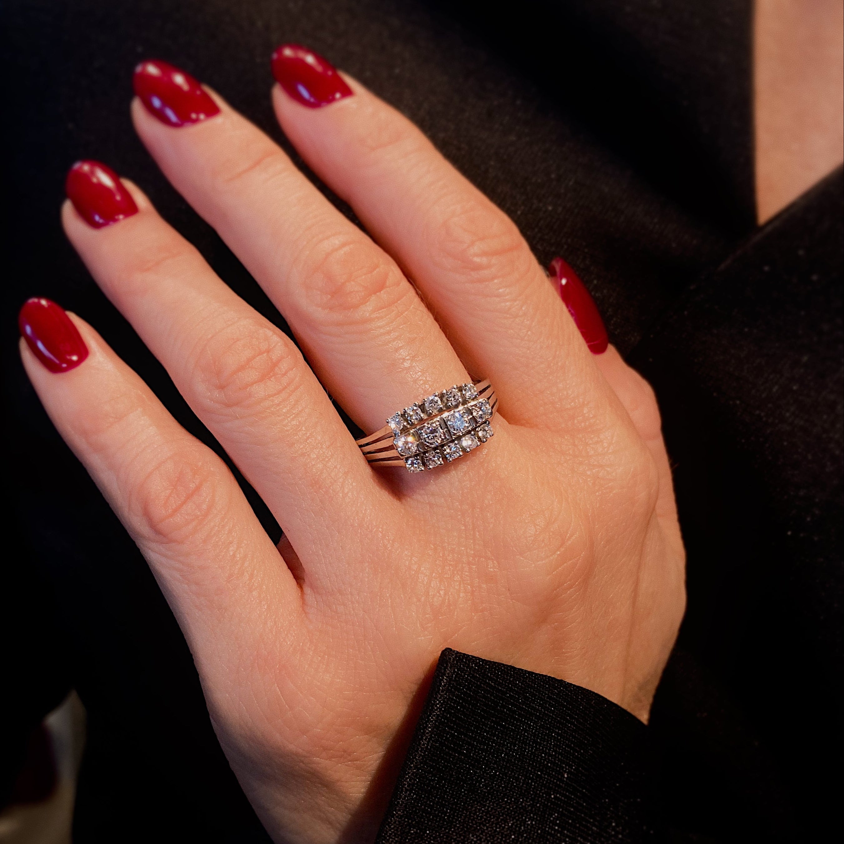 Woman model wearing the vintage Mid-Century white gold triple row diamond cocktail ring on hand.