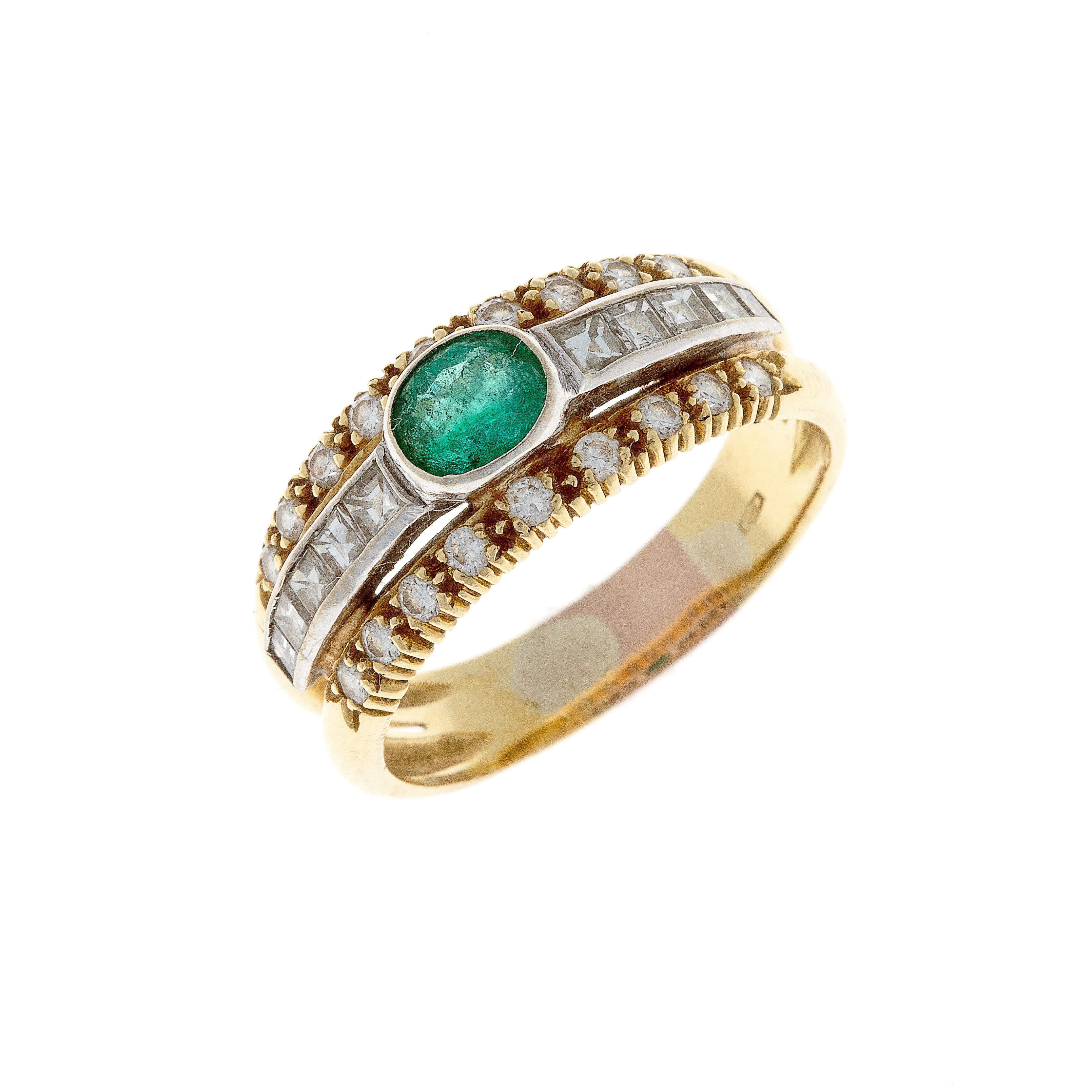 Angled view of an 18K white and yellow gold ring featuring a vivid emerald and pavé diamond details.