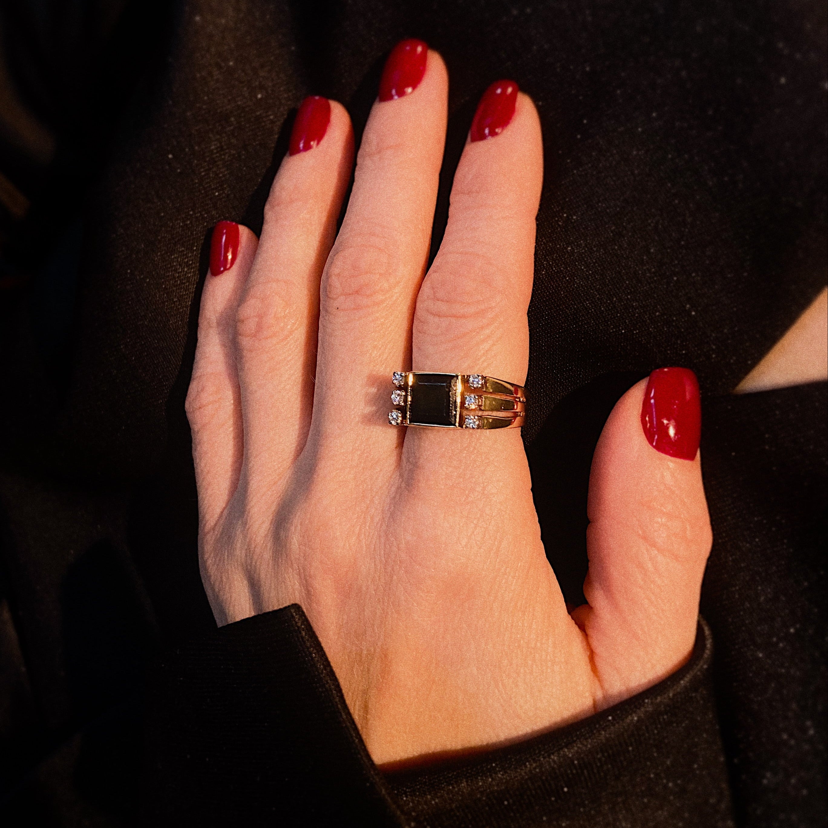 Model wearing the mid-century gold cocktail ring with tourmaline and diamond accents.