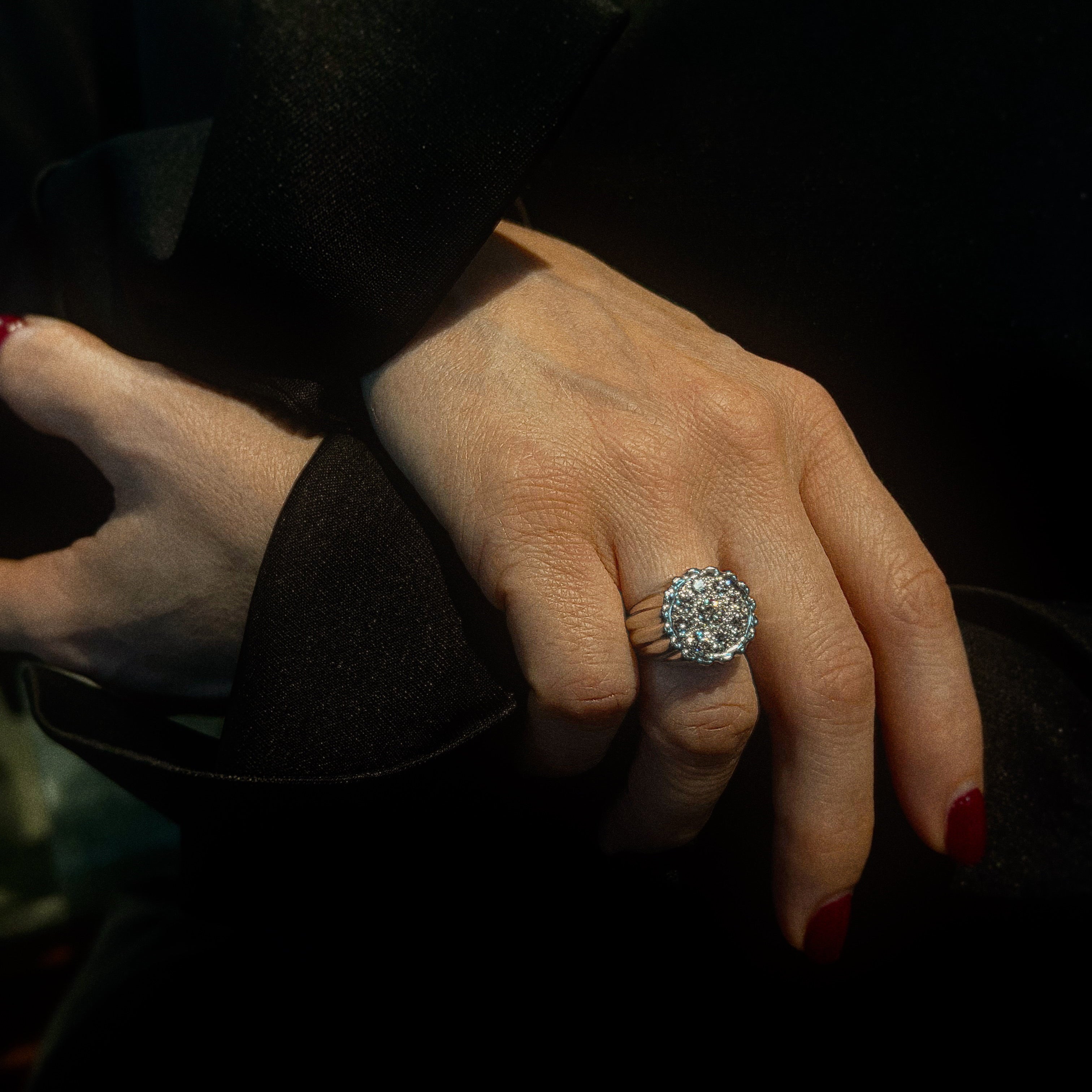 Model wearing the mid-century white gold diamond cluster cocktail ring.