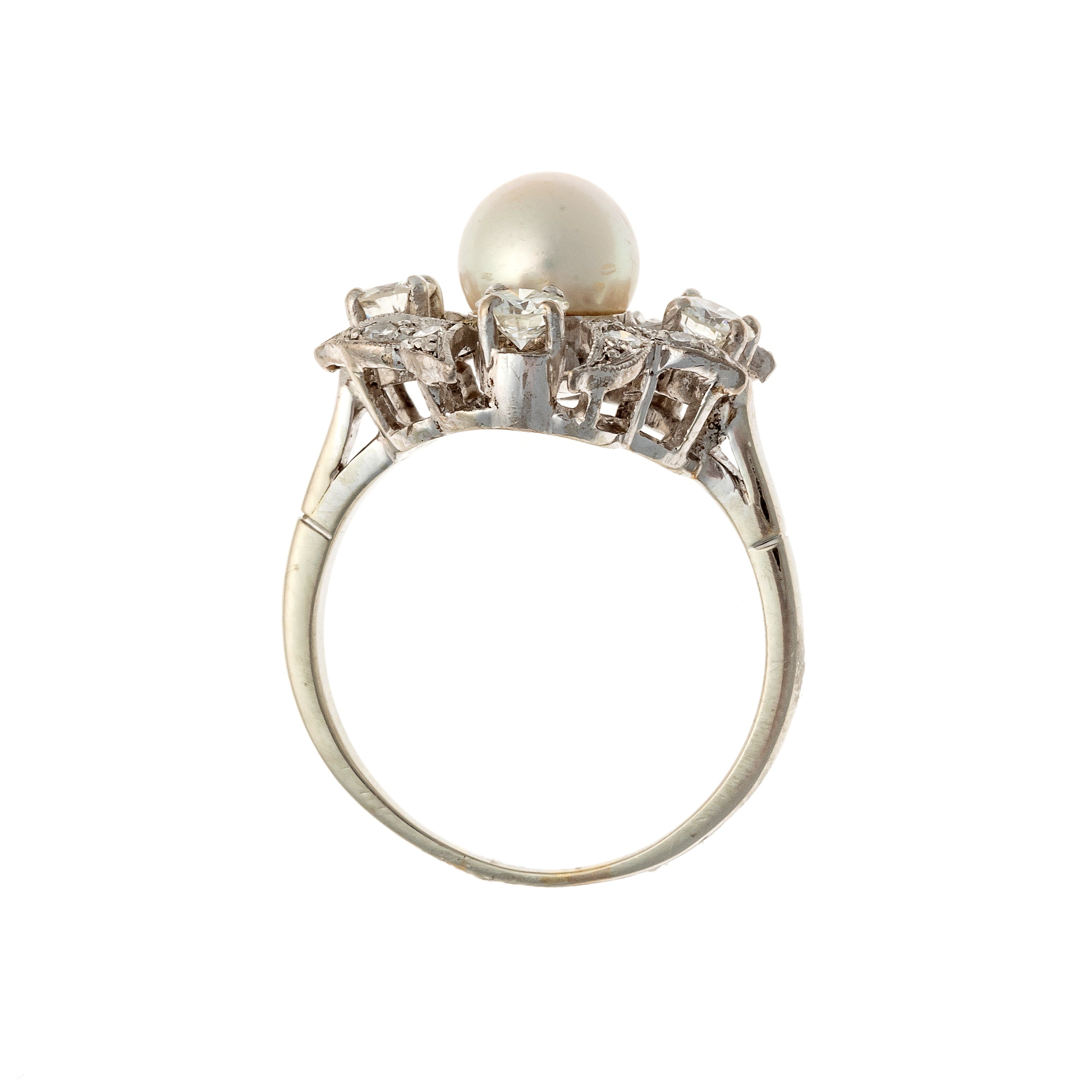 Profile of the mid-century white gold floral ring with pearl center and diamond petals.